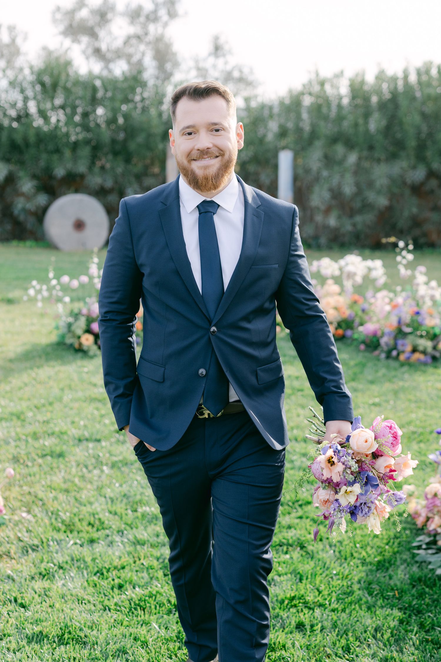 Wedding day floral decor in outdoor garden setting displays romantic pastel color palette.