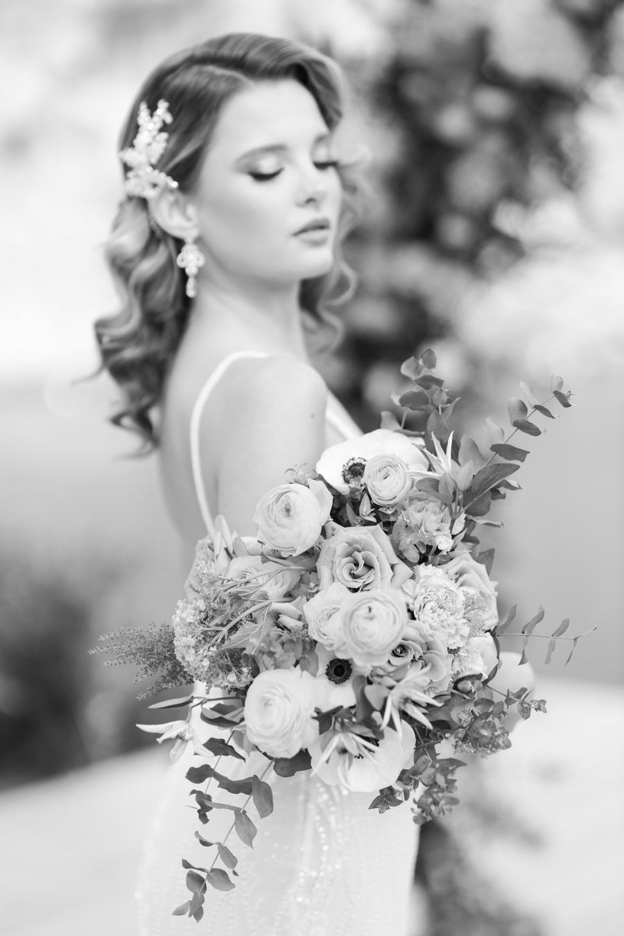 Artistic black and white portrait with romantic floral bouquet.