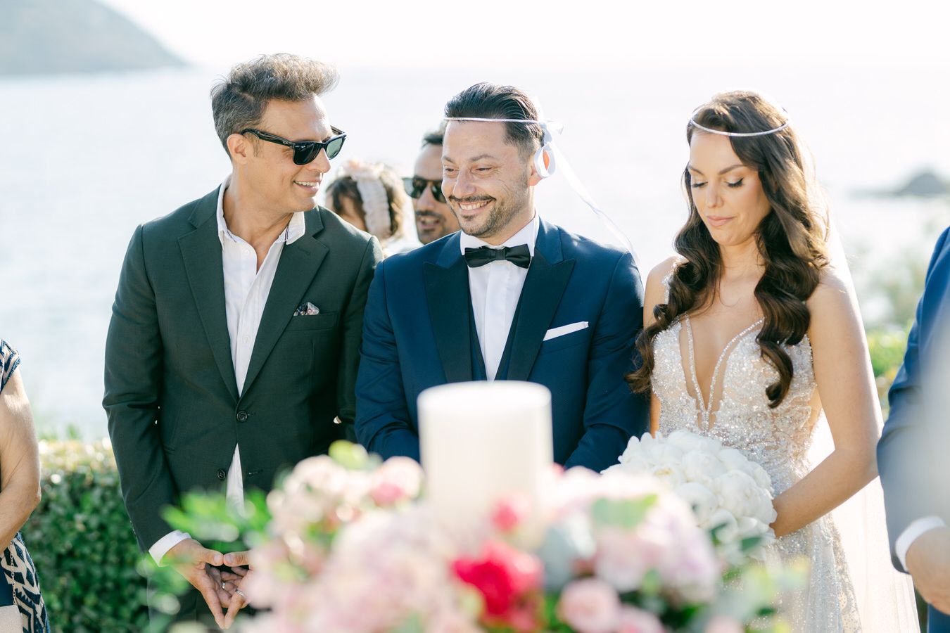 Wedding celebration moment with floral centerpiece arrangements outdoors.