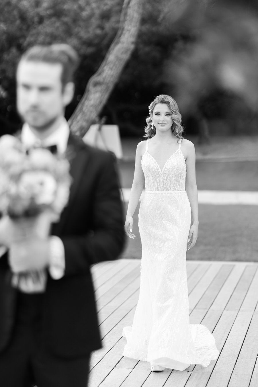 Elegant wedding photography on outdoor wooden deck.