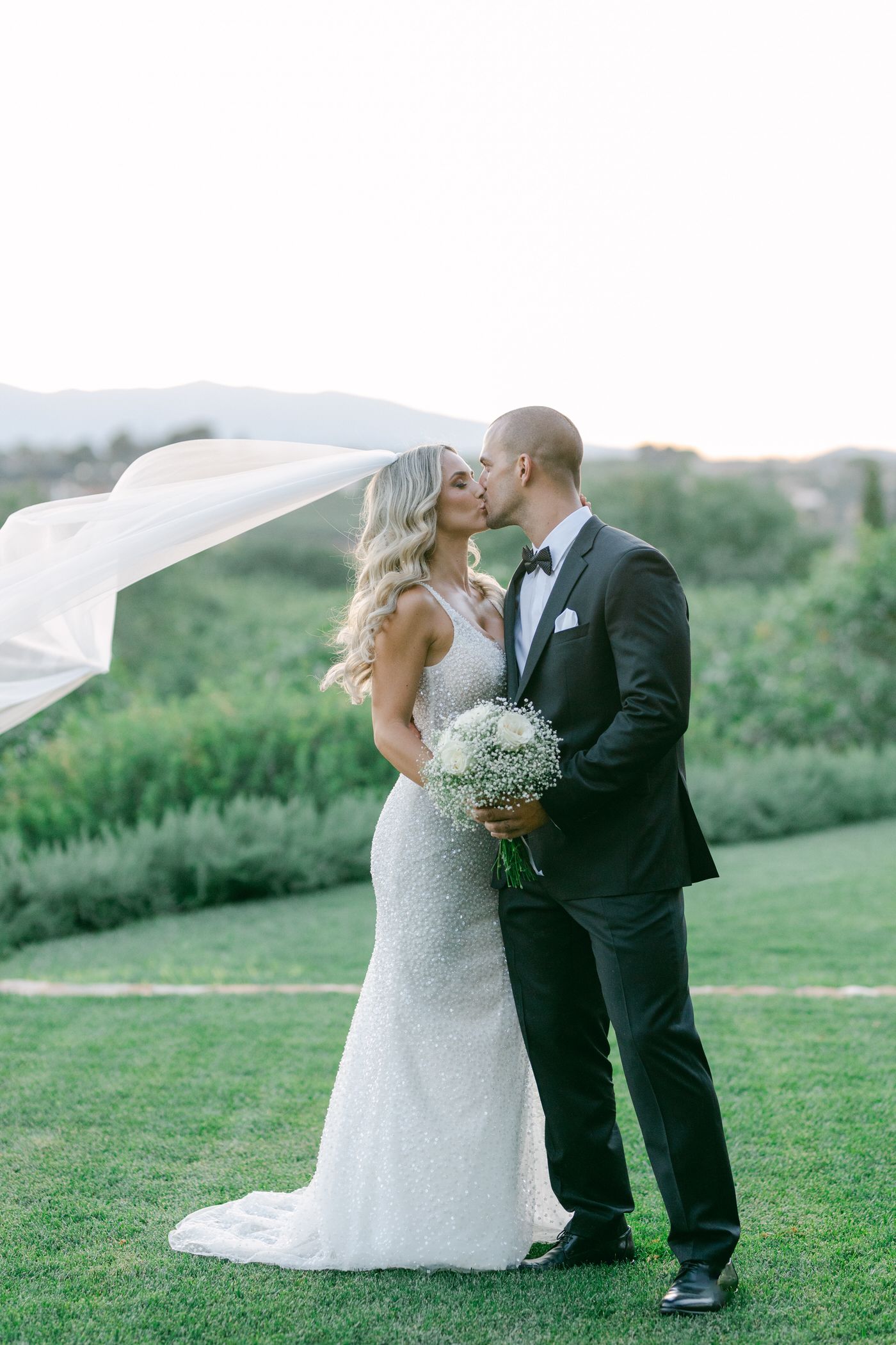 Bride and groom by the sea during an Athens Riviera wedding at golden hour in Greece.