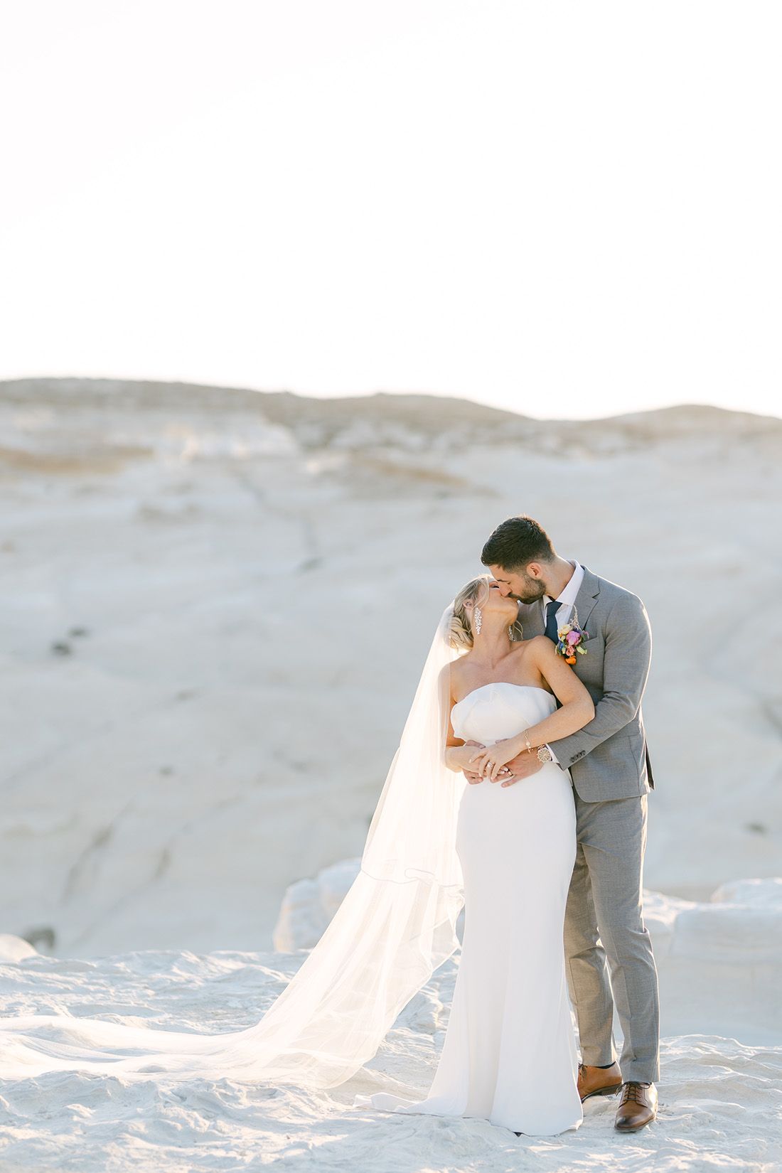 Couple portraits on the coastline in Milos, Greece, photographed in soft golden light.
