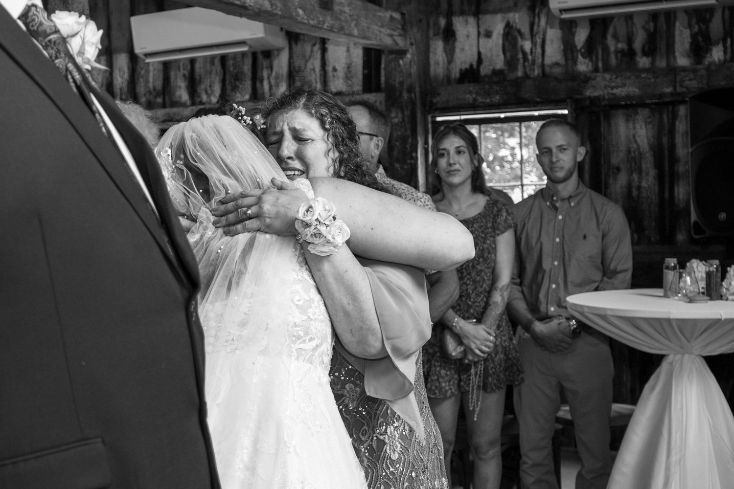 Black and white wedding reception photos showing guests celebrating and dancing.
