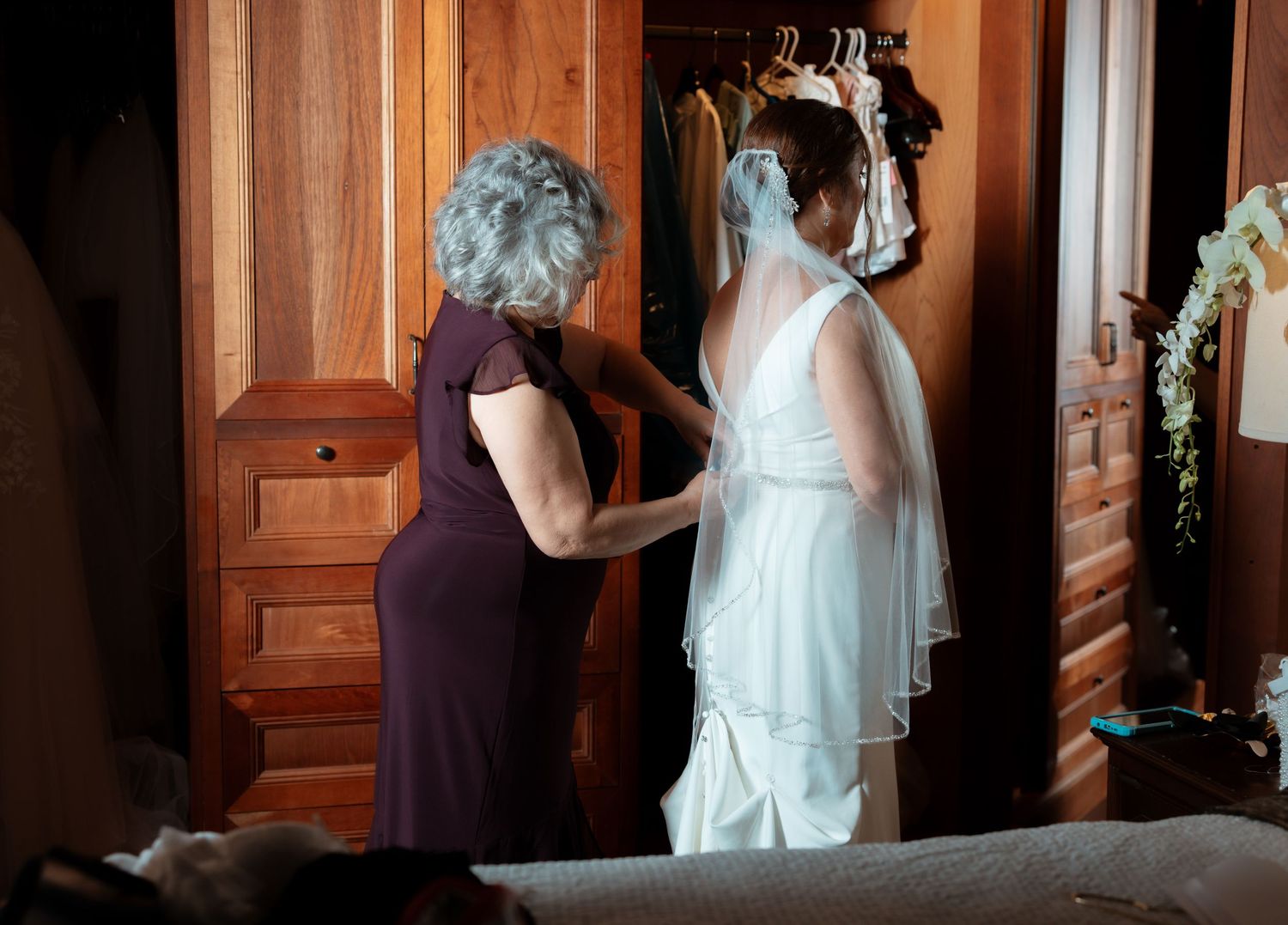 A series of black and white photos showing someone peeking through a wooden door in an elegant interior setting.