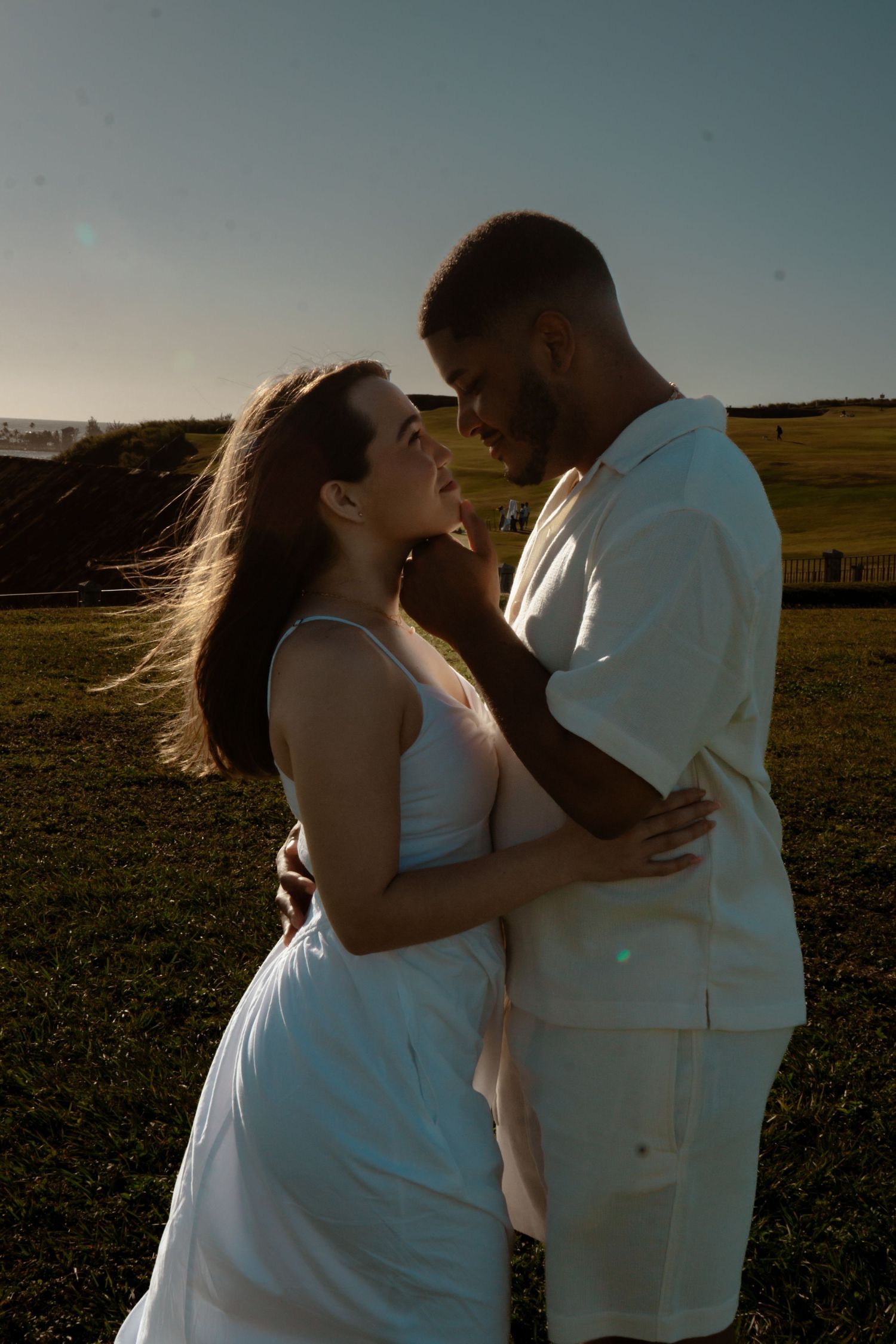 Romantic sunset moment captured in an open field with golden light.