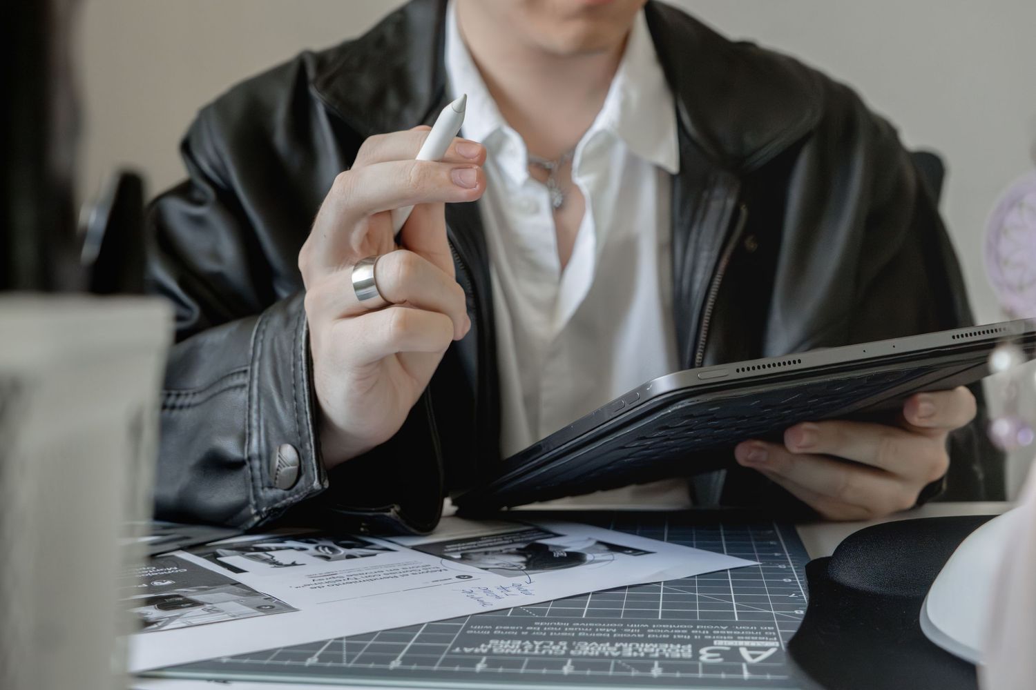 Business professional writing and working at desk with documents.
