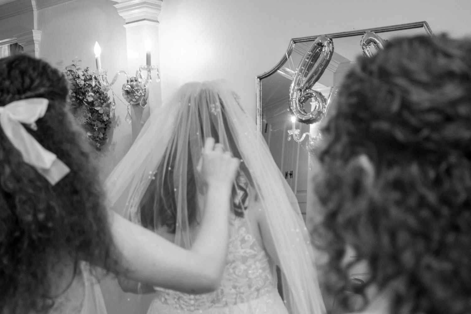 Intimate wedding preparation moment captured in soft natural light.