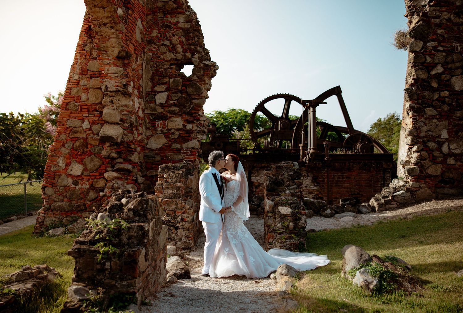 Artistic wedding portraits taken among historic stone ruins during golden hour.