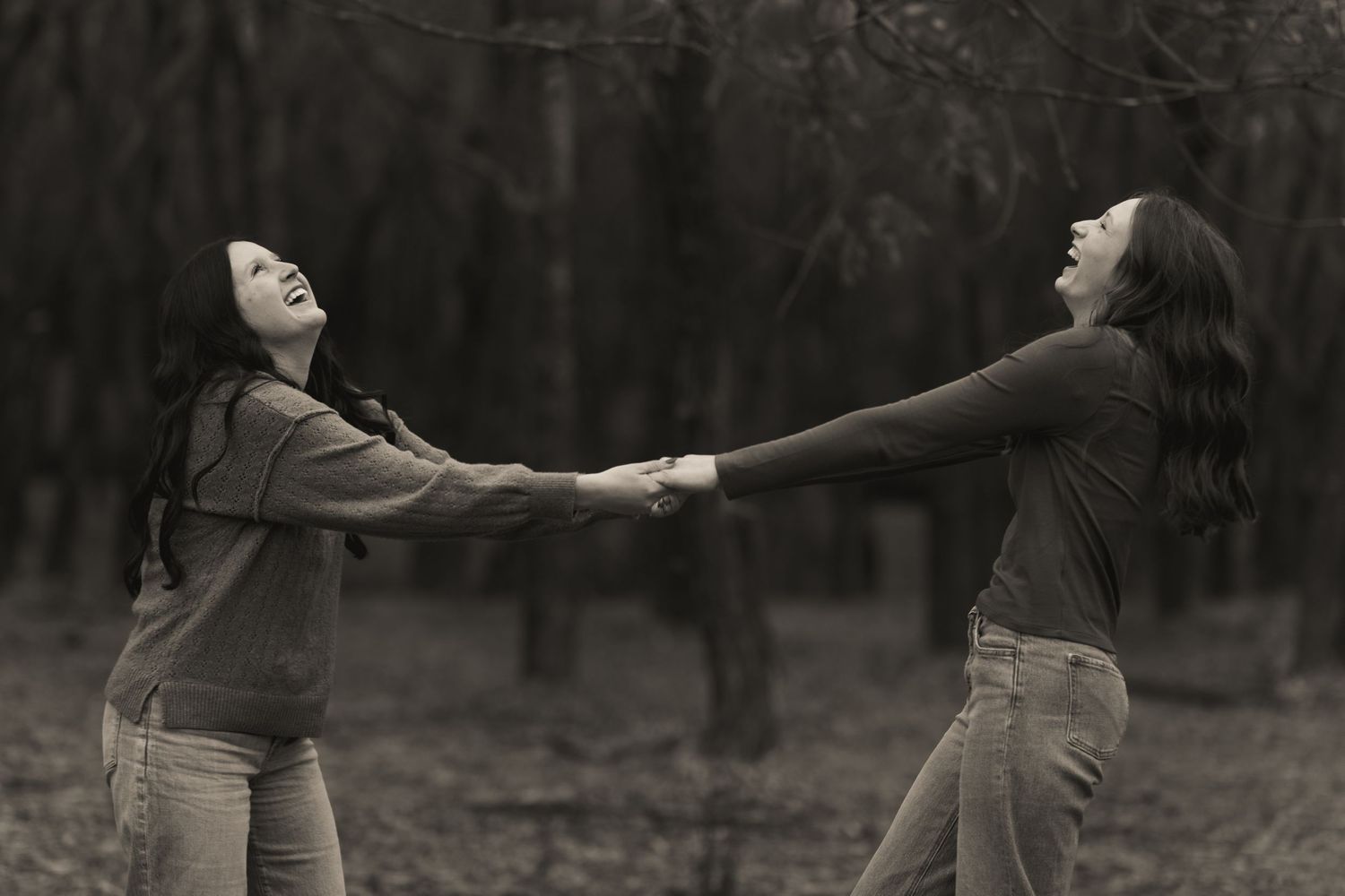 A black and white photo series showing a person dancing expressively in a forest setting.