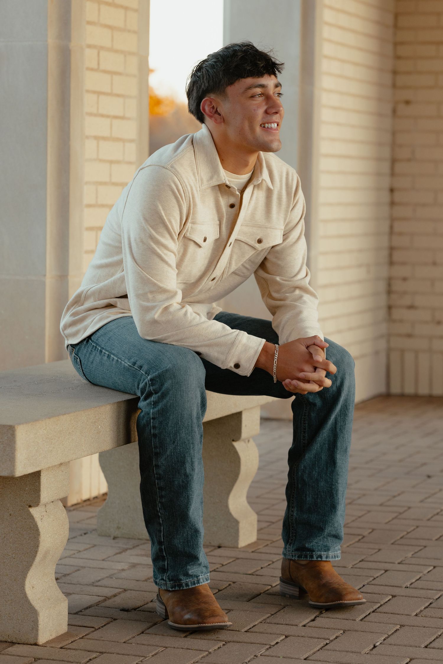 A candid moment captured of someone relaxing on outdoor brick steps.