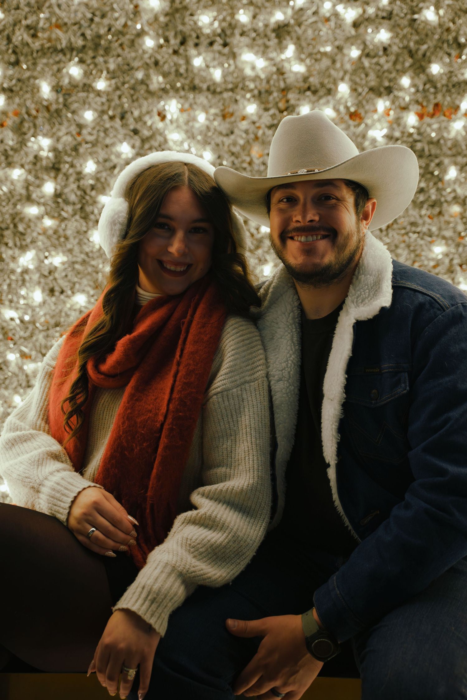 A couple in winter attire sharing intimate moments against a sparkly bokeh background in a photo series.