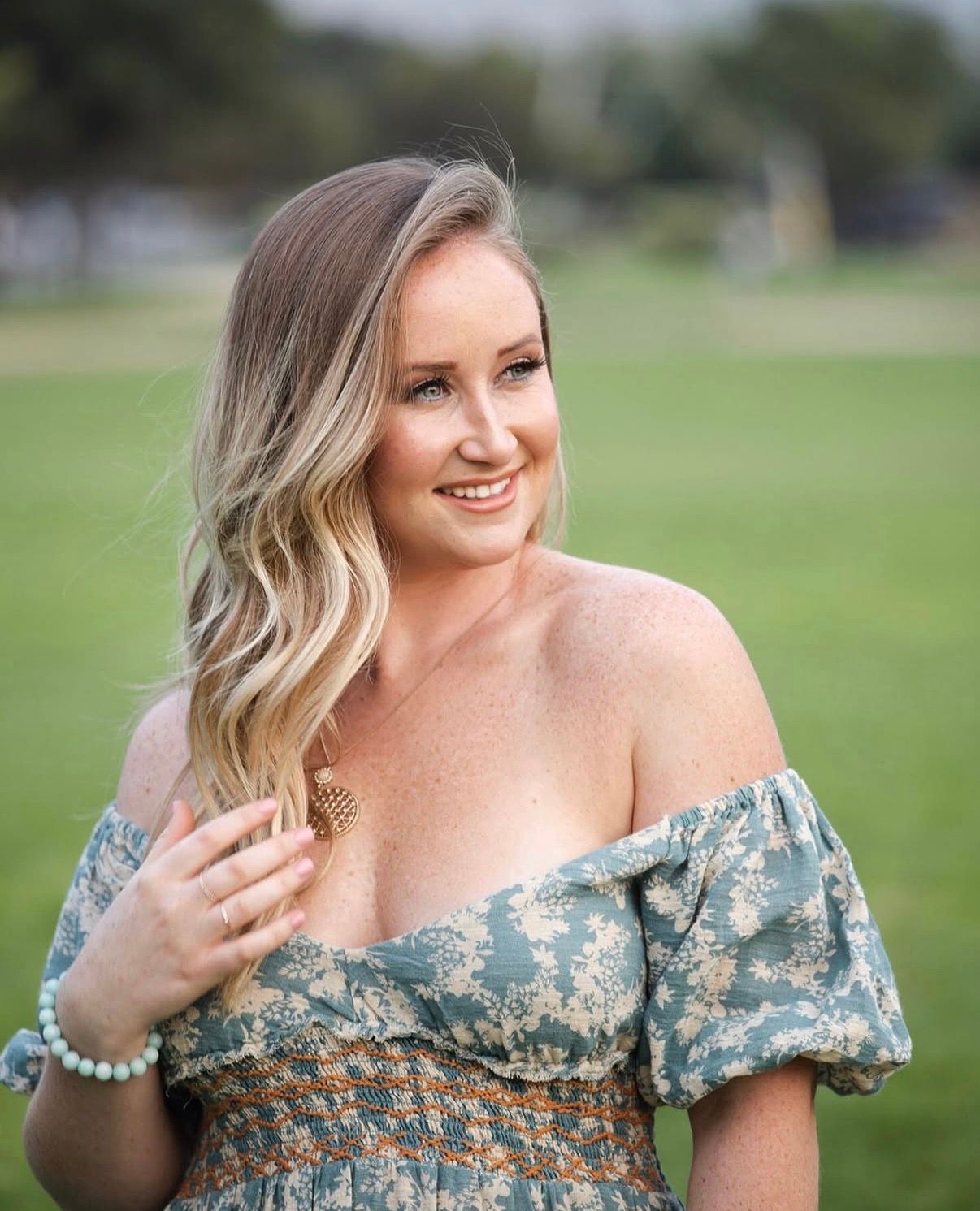 A series of photos showing someone wearing a floral off-shoulder dress in an outdoor setting with green grass.