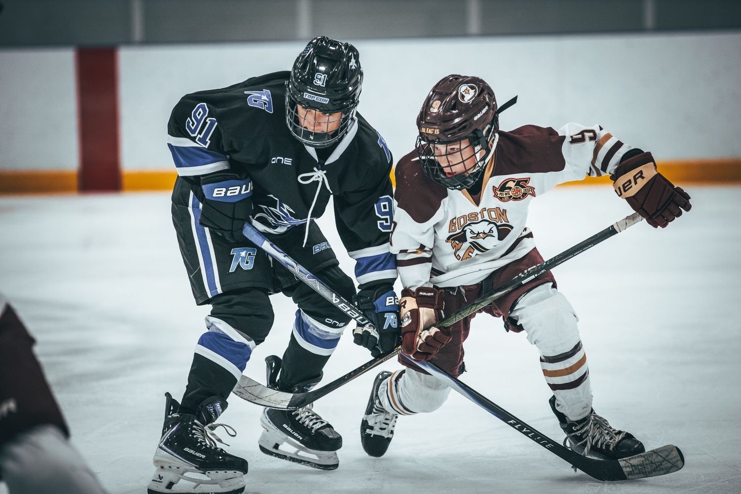 Hockey players battle for control of the puck during an intense ice hockey game.