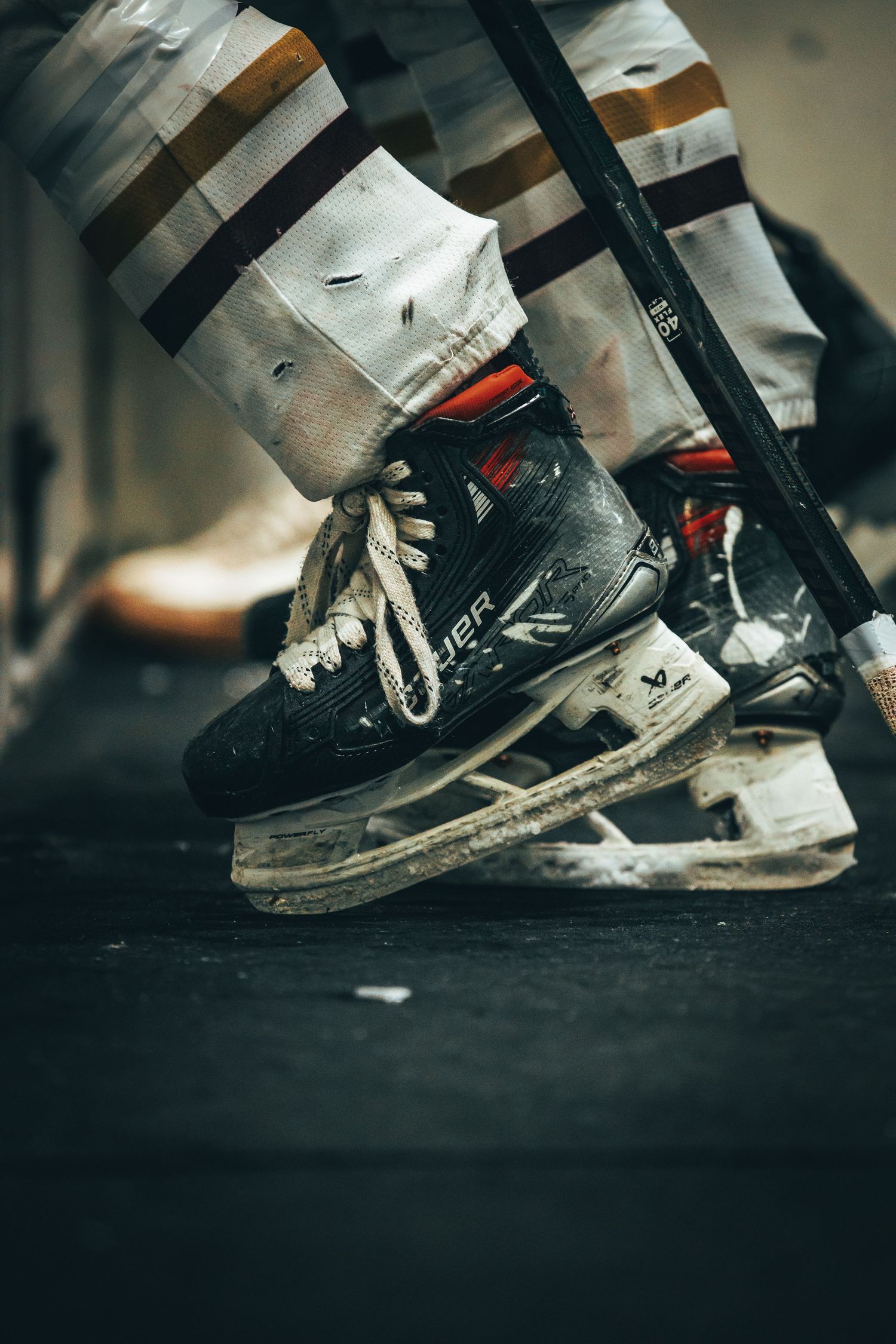 Close-up shots of well-worn athletic shoes in motion against a dark background showing signs of heavy use.