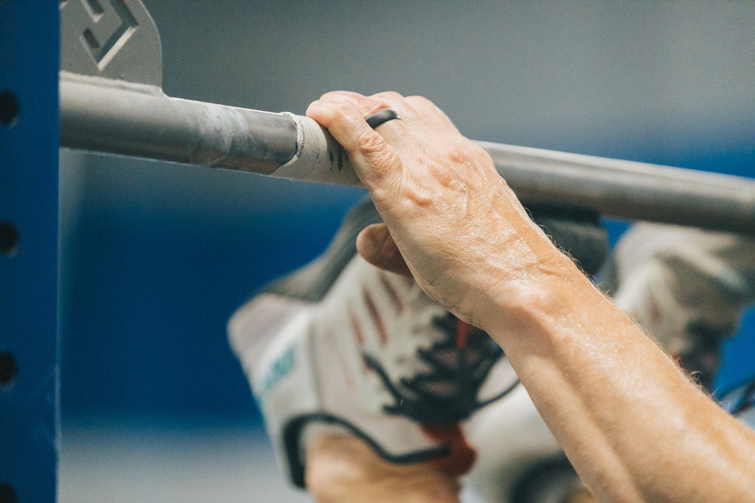 Close-up sequence showing hands kneading and shaping dough on a blue surface.