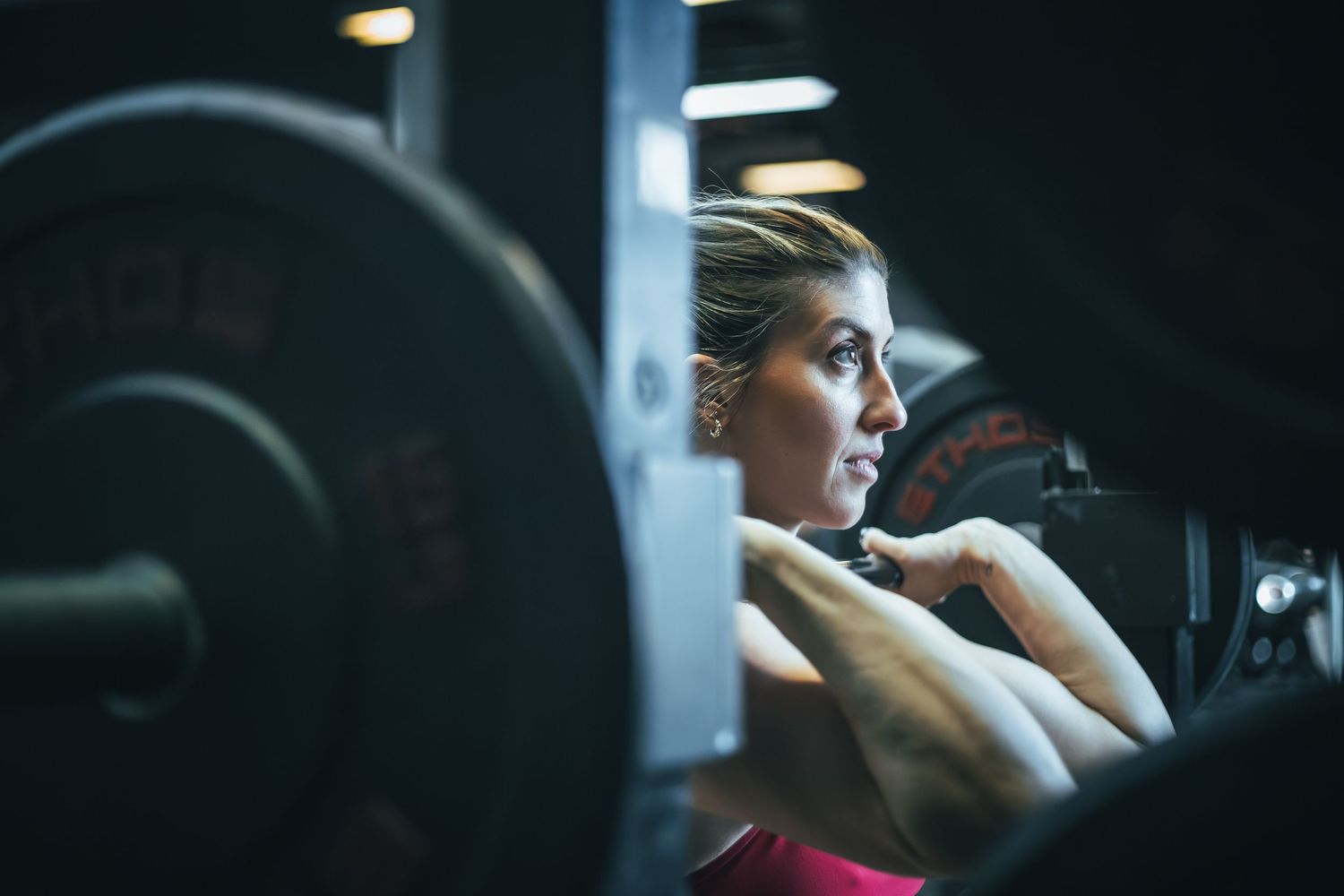 A sequence of images showing someone working out on gym equipment in a dimly lit fitness center.