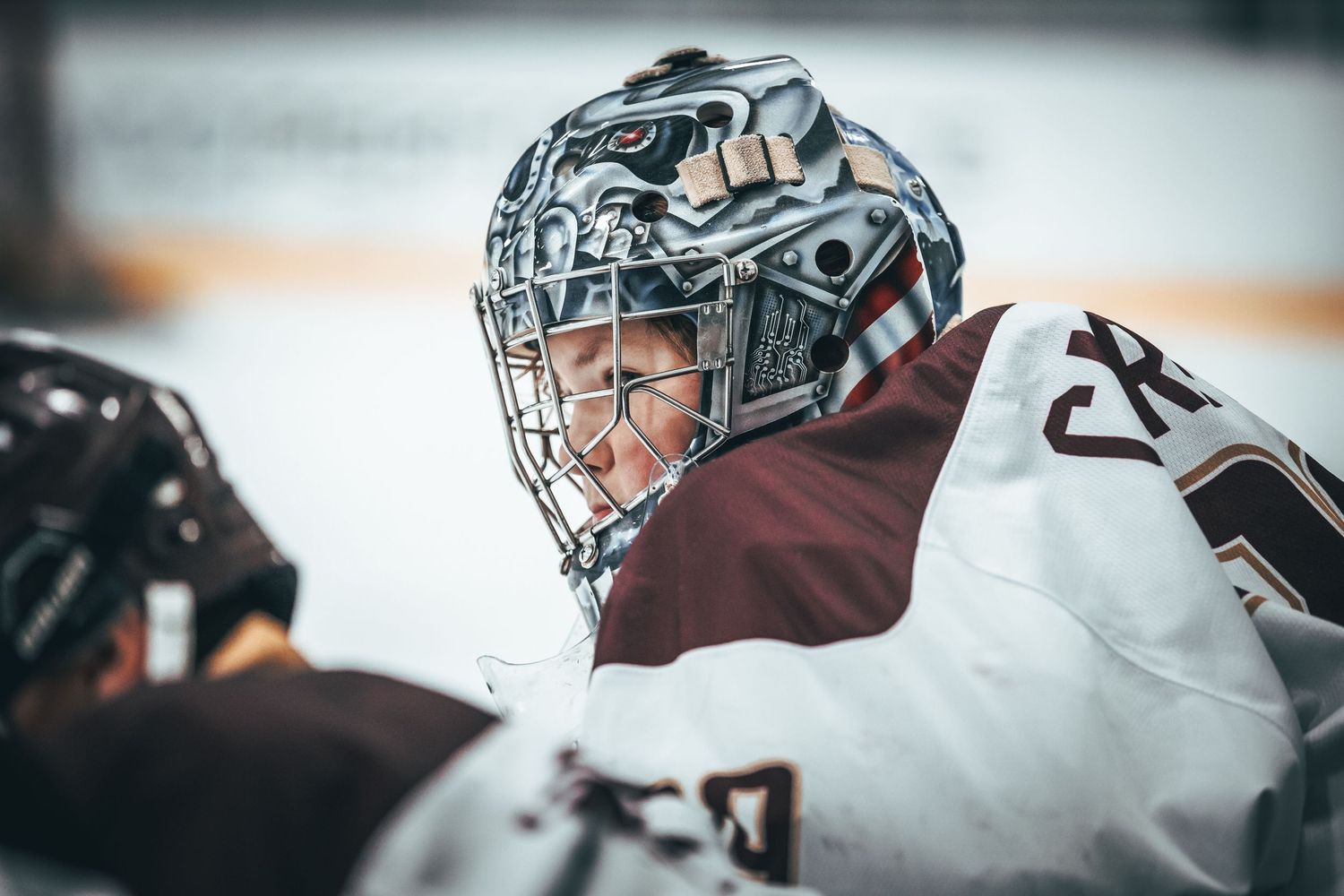 A series of NHL goalie helmet close-up shots showing detailed mask artwork and protective equipment designs.