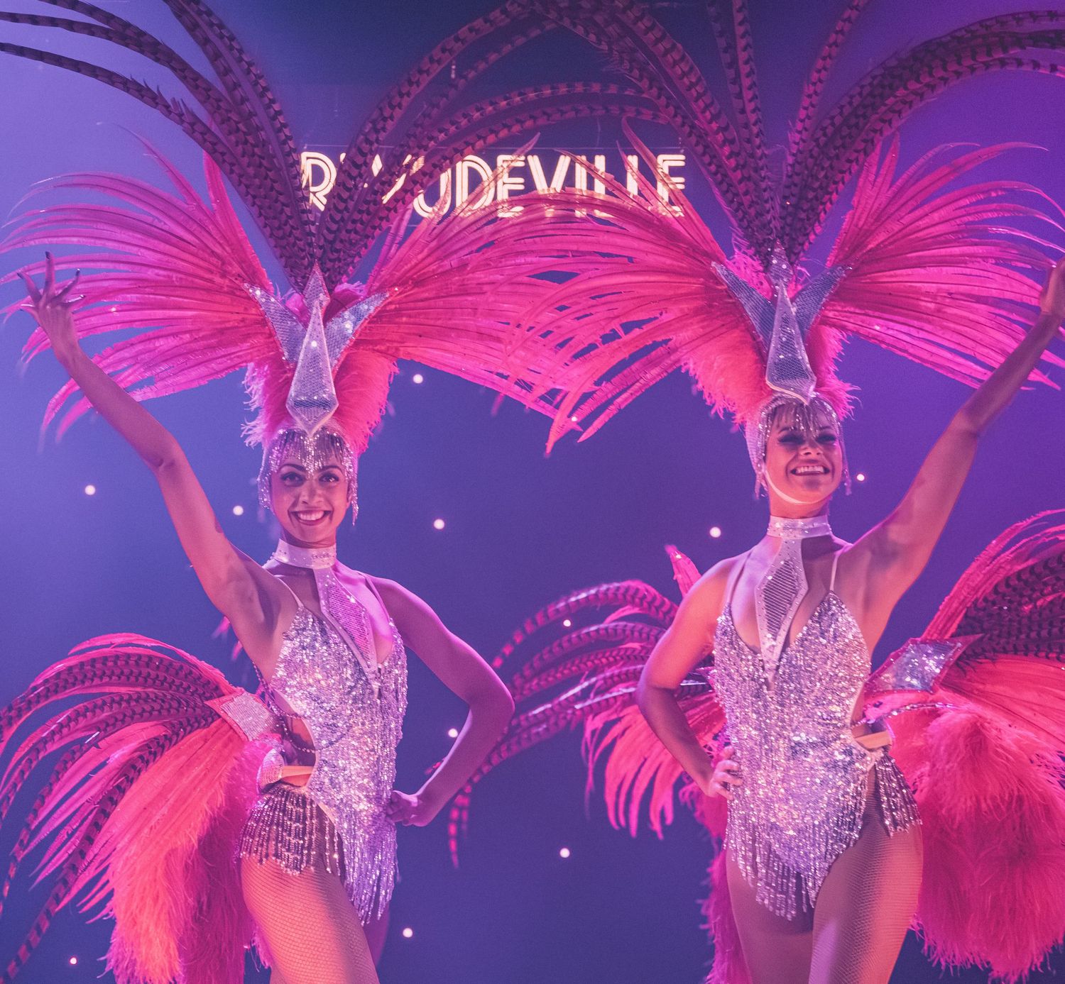 Dancers in matching silver costumes and pink feathered headdresses perform at Revudeville.