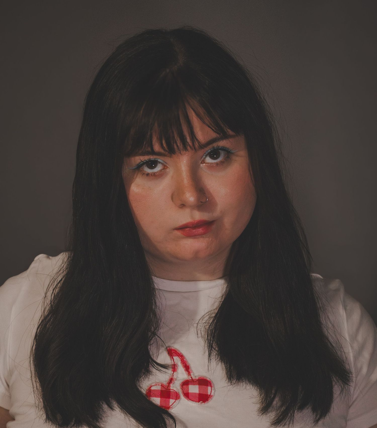Portrait with dramatic lighting and vintage-inspired styling.