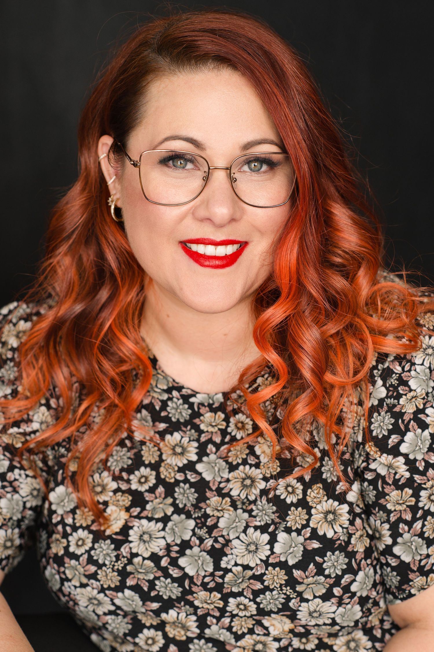 Portrait series showing vibrant red hair and floral print dress against dark background.