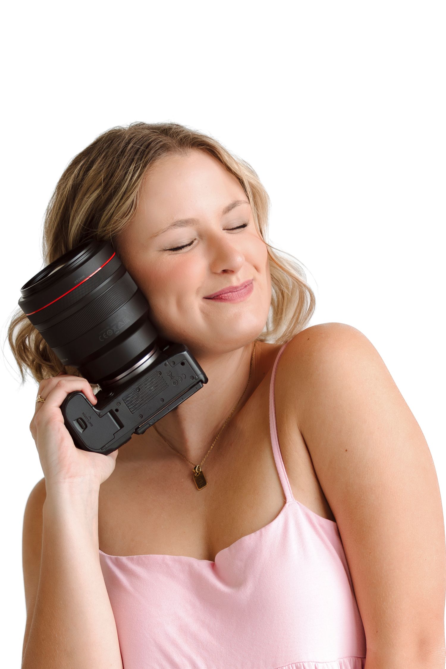 Woman in pink top listening to music with black headphones in multiple poses against white background.