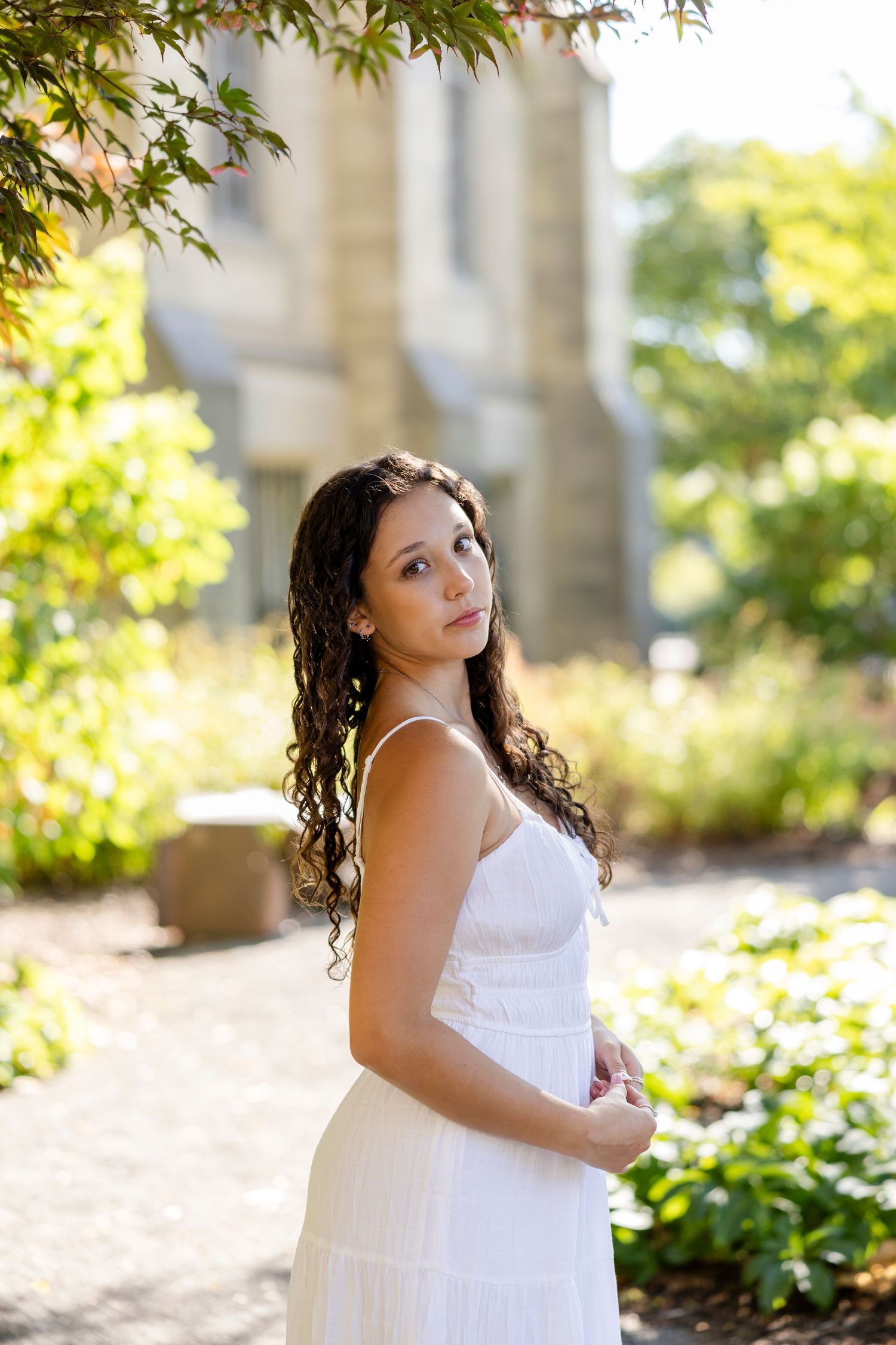 Sunlit outdoor portraits with natural foliage and architectural elements at the Memorial Art Gallery, Rochester, NY.