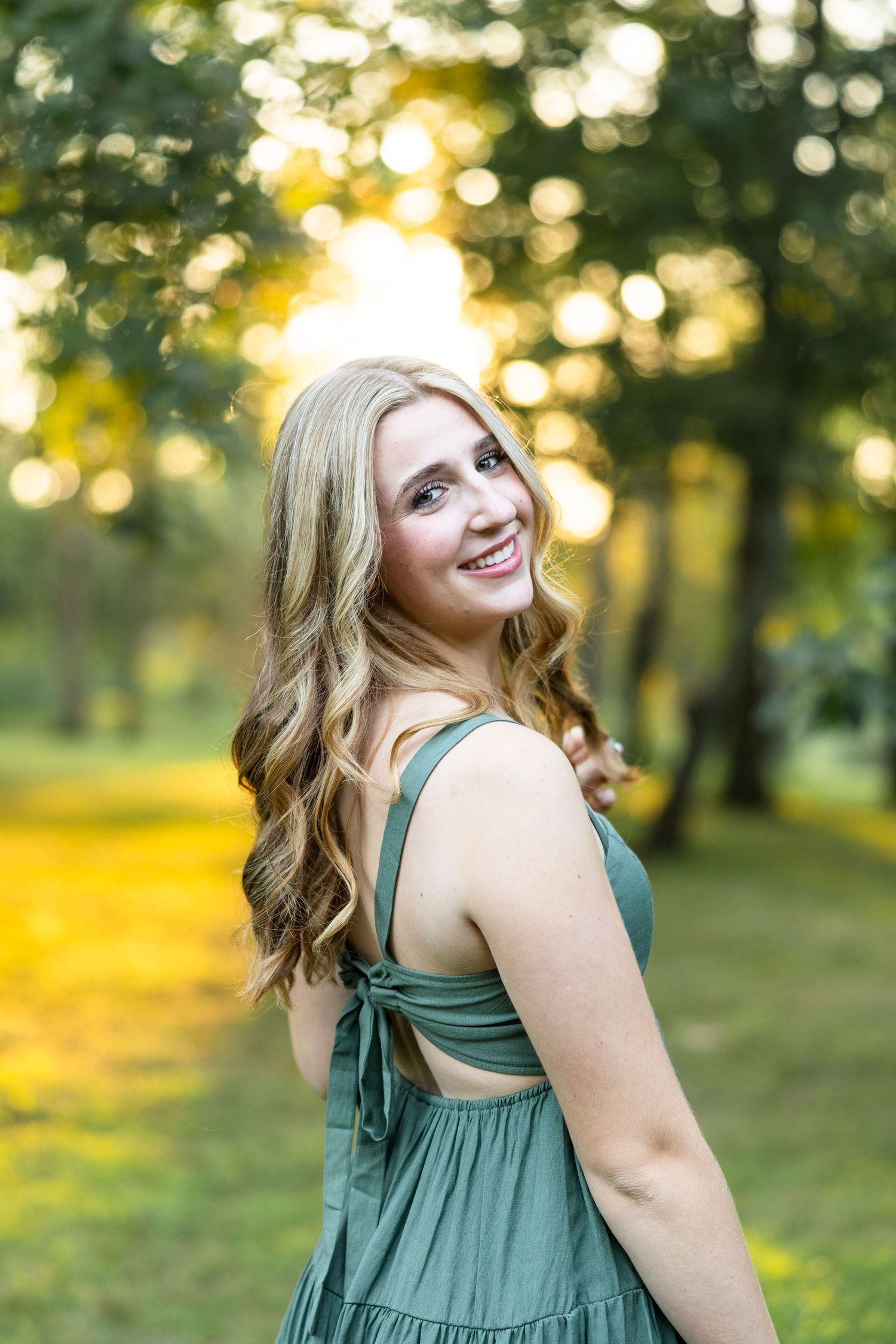 Sunset portrait session in sage green dress with natural golden lighting in Webster. Webster senior portaits.
