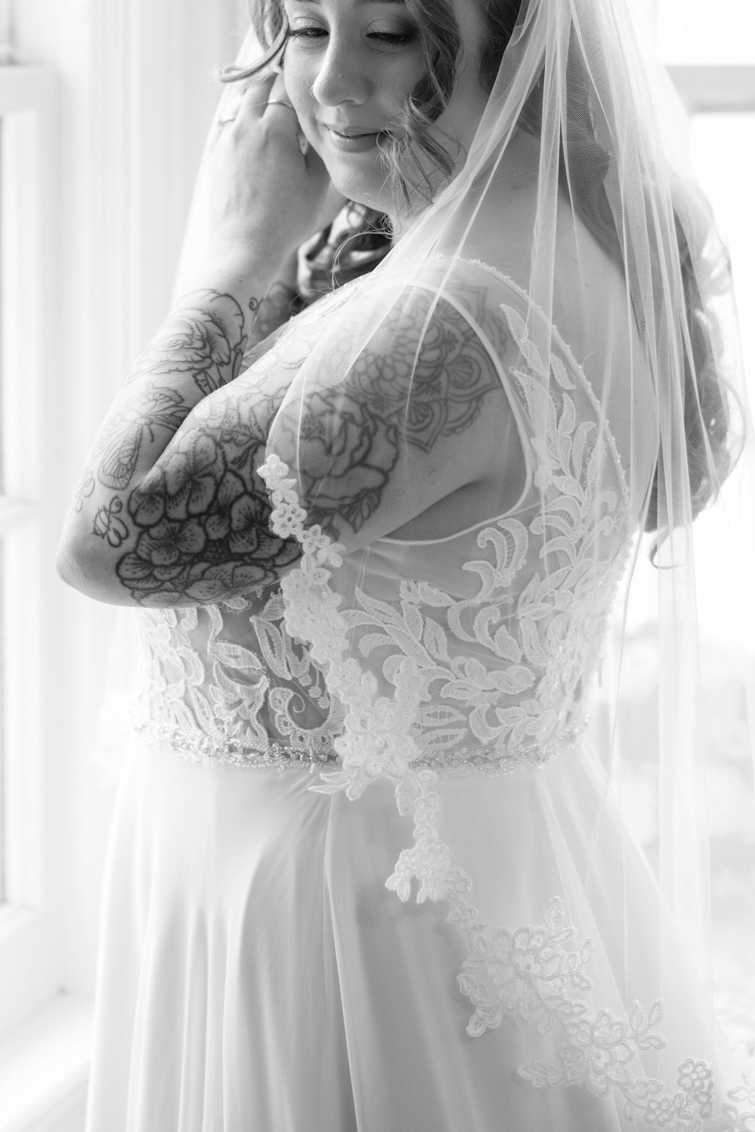 Ethereal bridal portrait featuring delicate lace details and flowing veil in soft natural light at Whitehall Mansion, Brockport, NY.