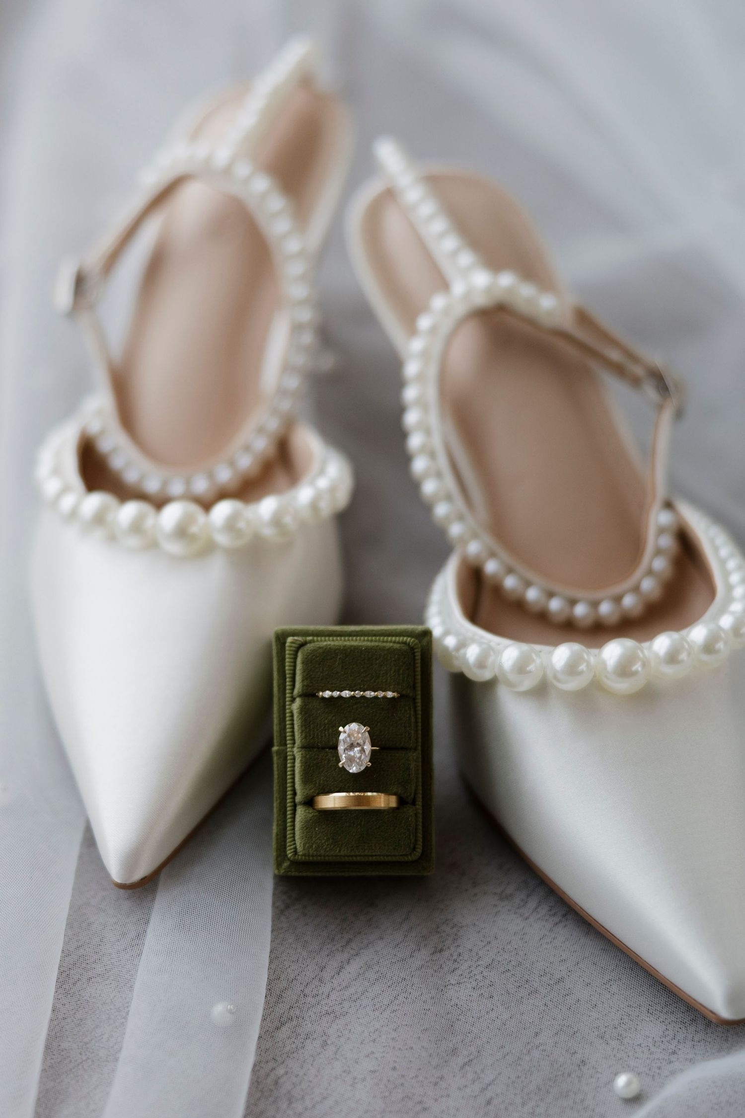 White bridal shoes with pearl straps and engagement ring in green velvet box at Fallbrook House December Wedding in Canandaigua, NY.