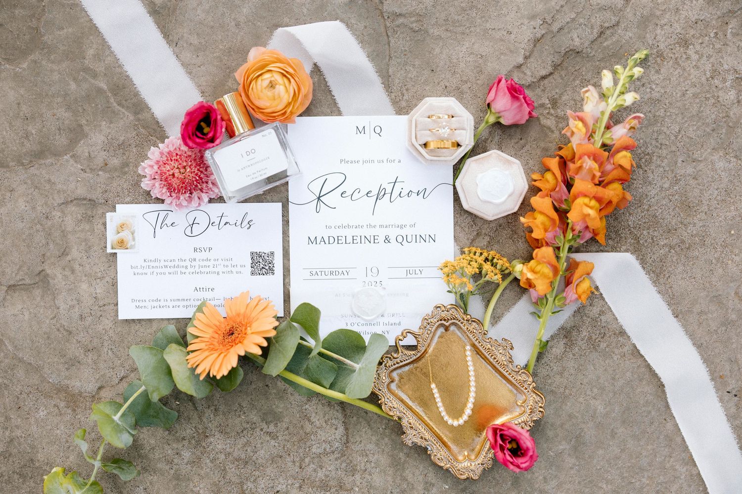 Wedding stationery and invitation suite styled with fresh pink and orange flowers and elegant details at Wilson NY wedding reception.