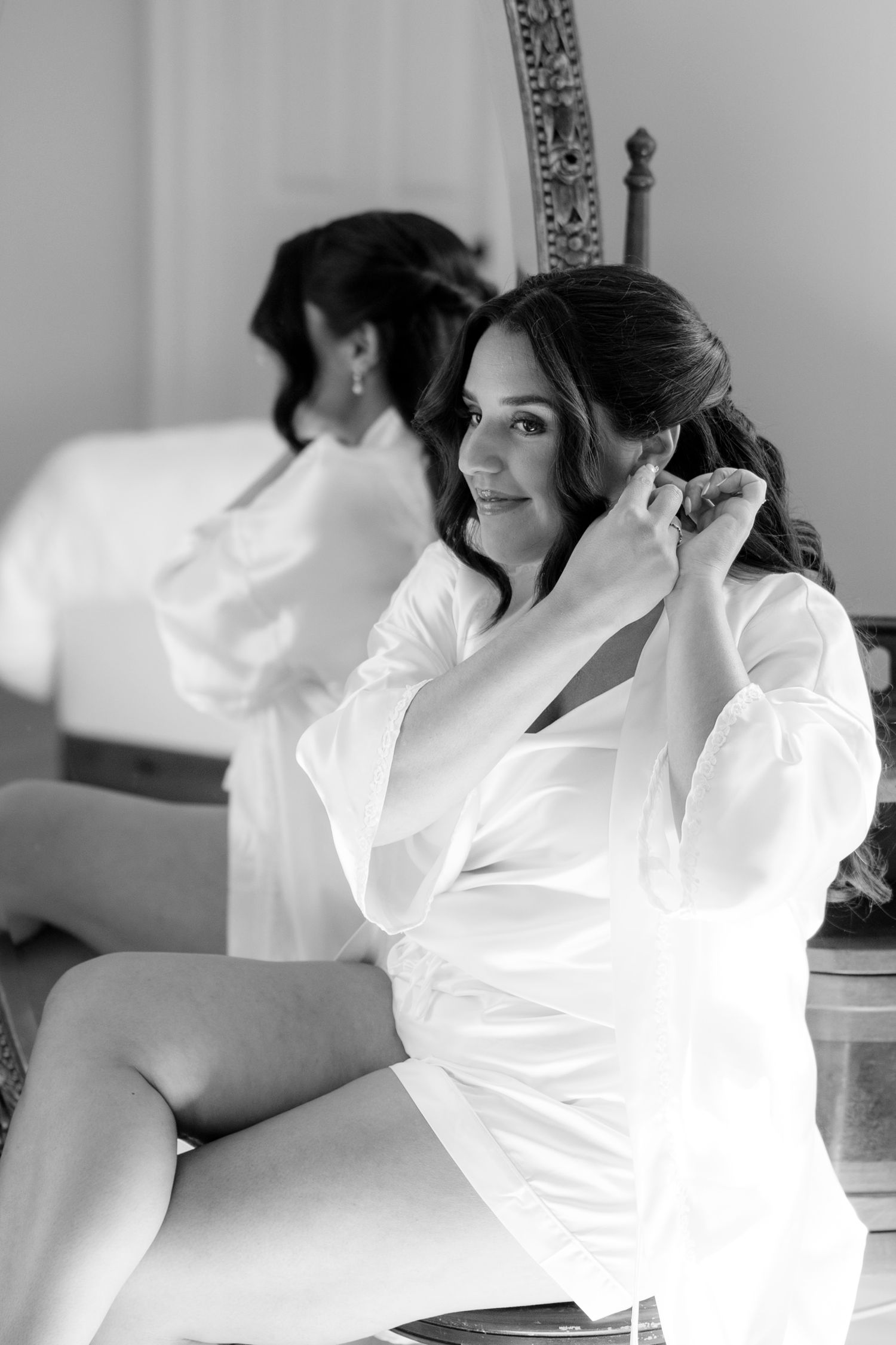 Black and white portrait series showing bride in white robe against vanity background at the Cayuga Shoreline. Fingerlakes wedding.