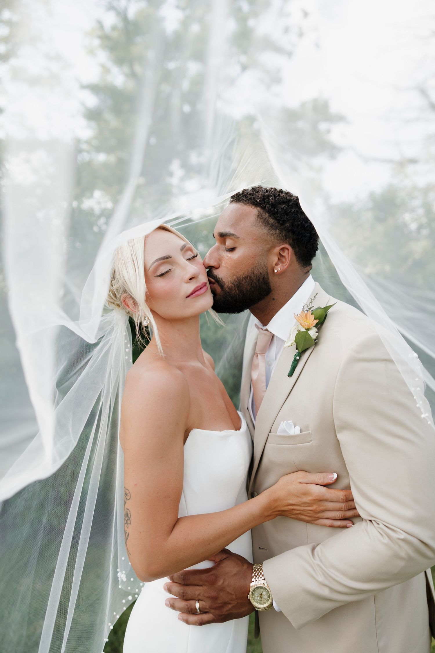 Intimate wedding portrait under flowing veil with soft forest backdrop at Pennsylvania wedding portaits. Rochester NY wedding photographer.