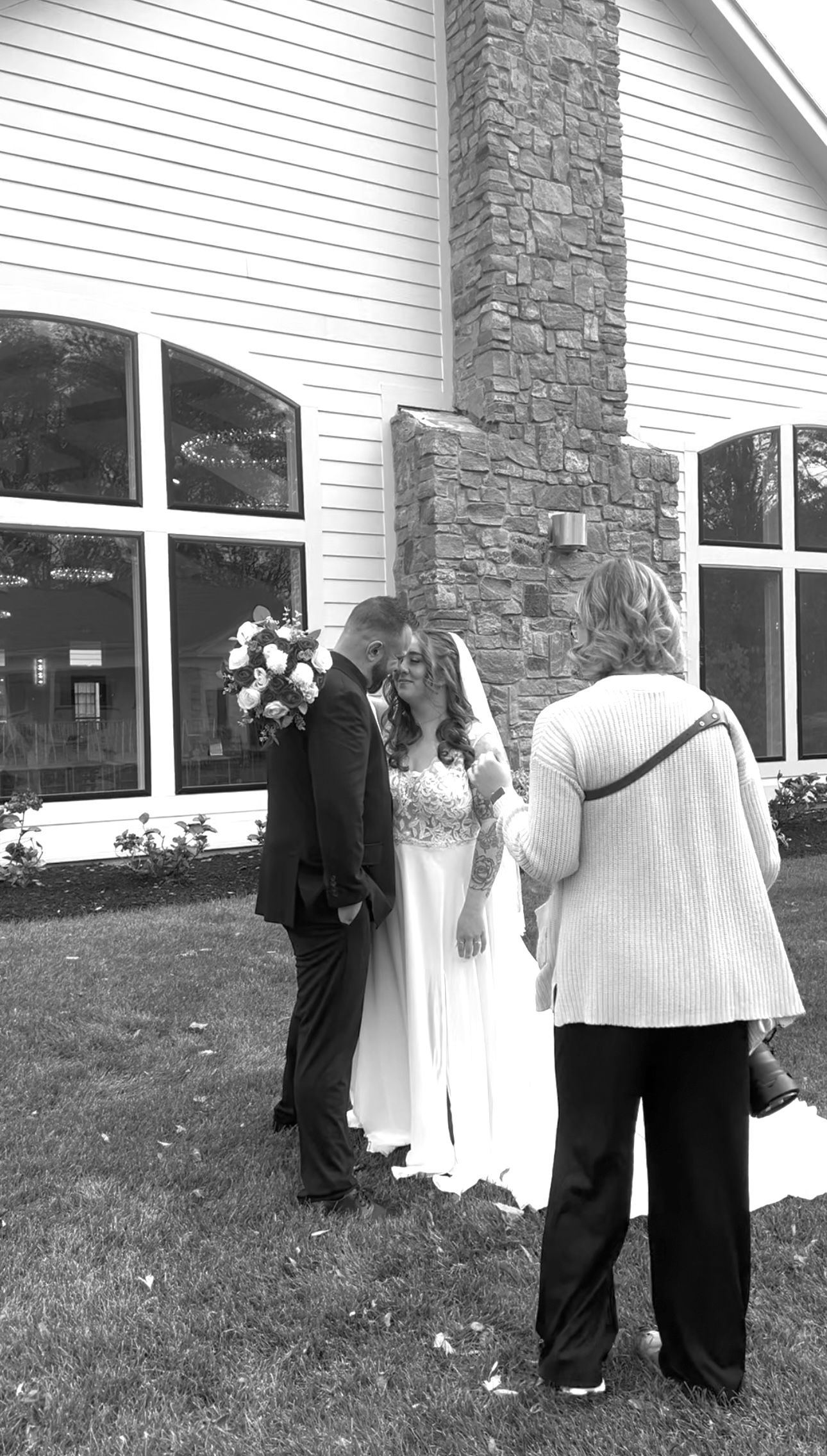 A wedding photography session outside a white stone building.