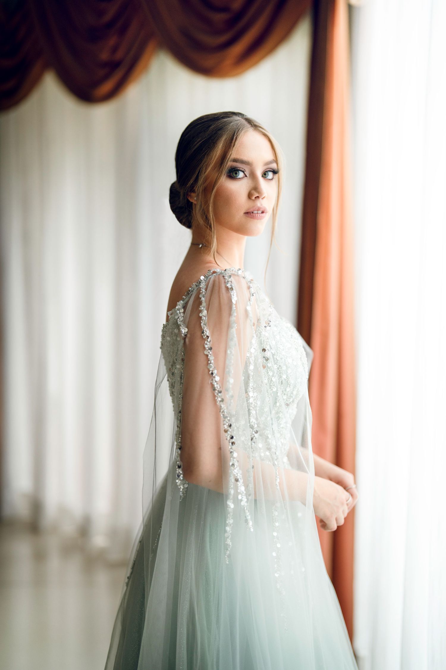 Ethereal bridal portrait featuring delicate lace veil and mint green wedding gown.