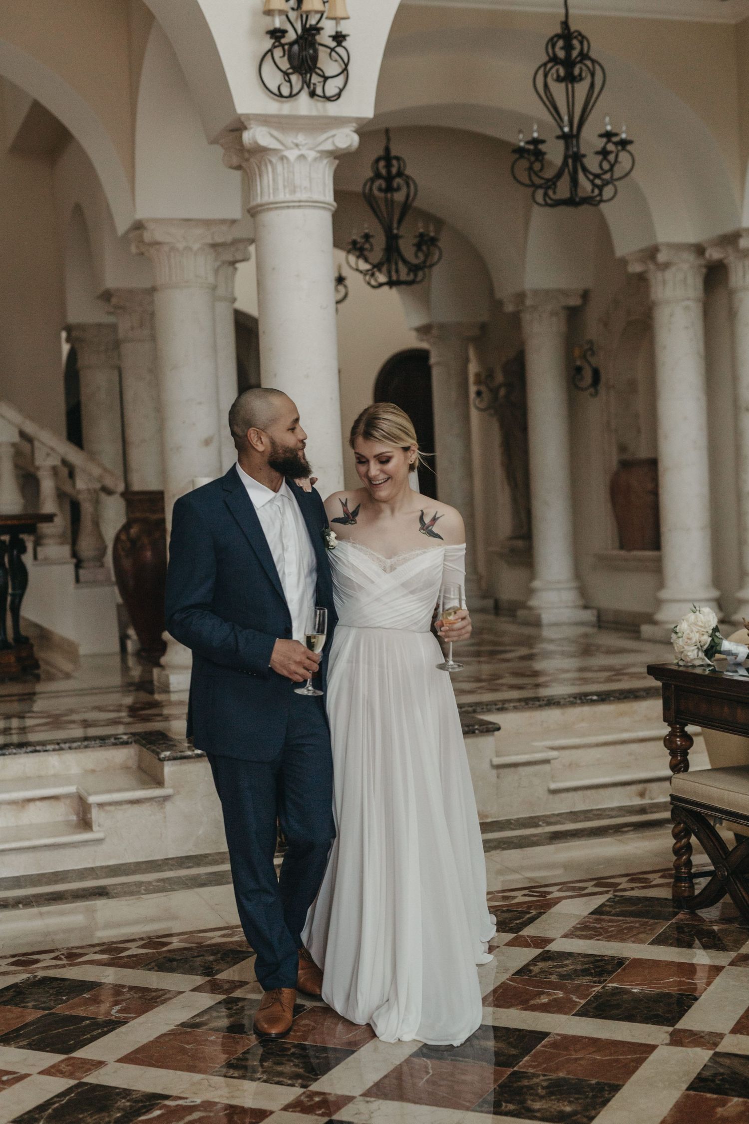 Elegant wedding portrait of bride and groom in grand hall at Villa la Joya Playa del Carmen Riviera Maya photographer.