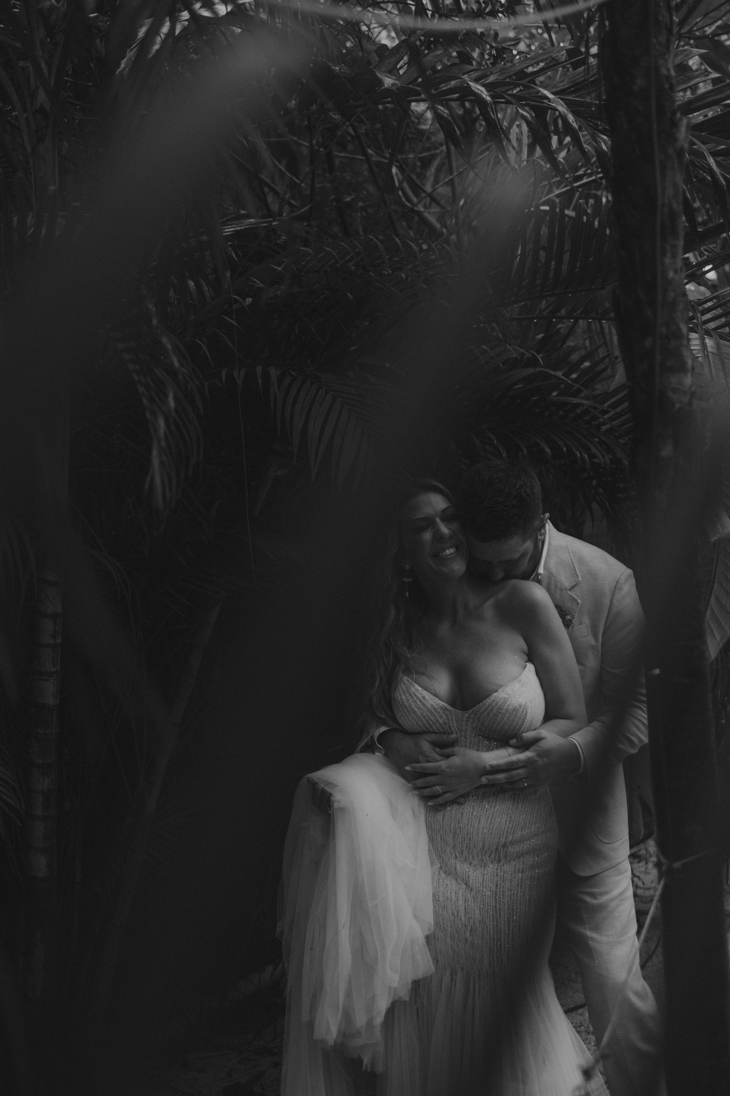 Black and white photo of bride and groom in an intimate jungle setting during a Tulum wedding at NU Tulum