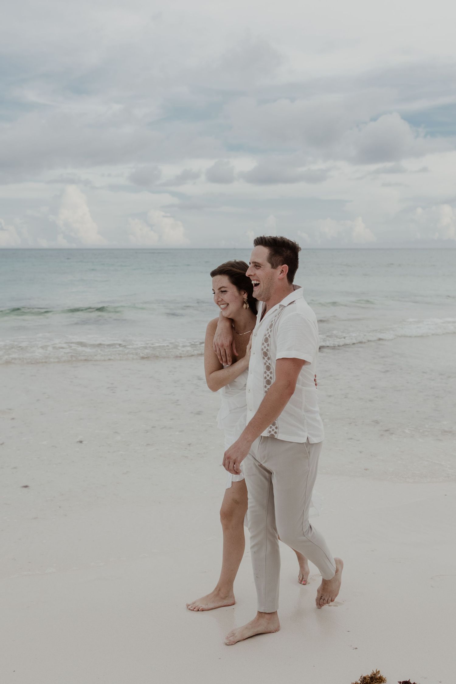 Romantic engagement photoshoot by the turquoise sea at Playa Xpu Ha, Riviera Maya.