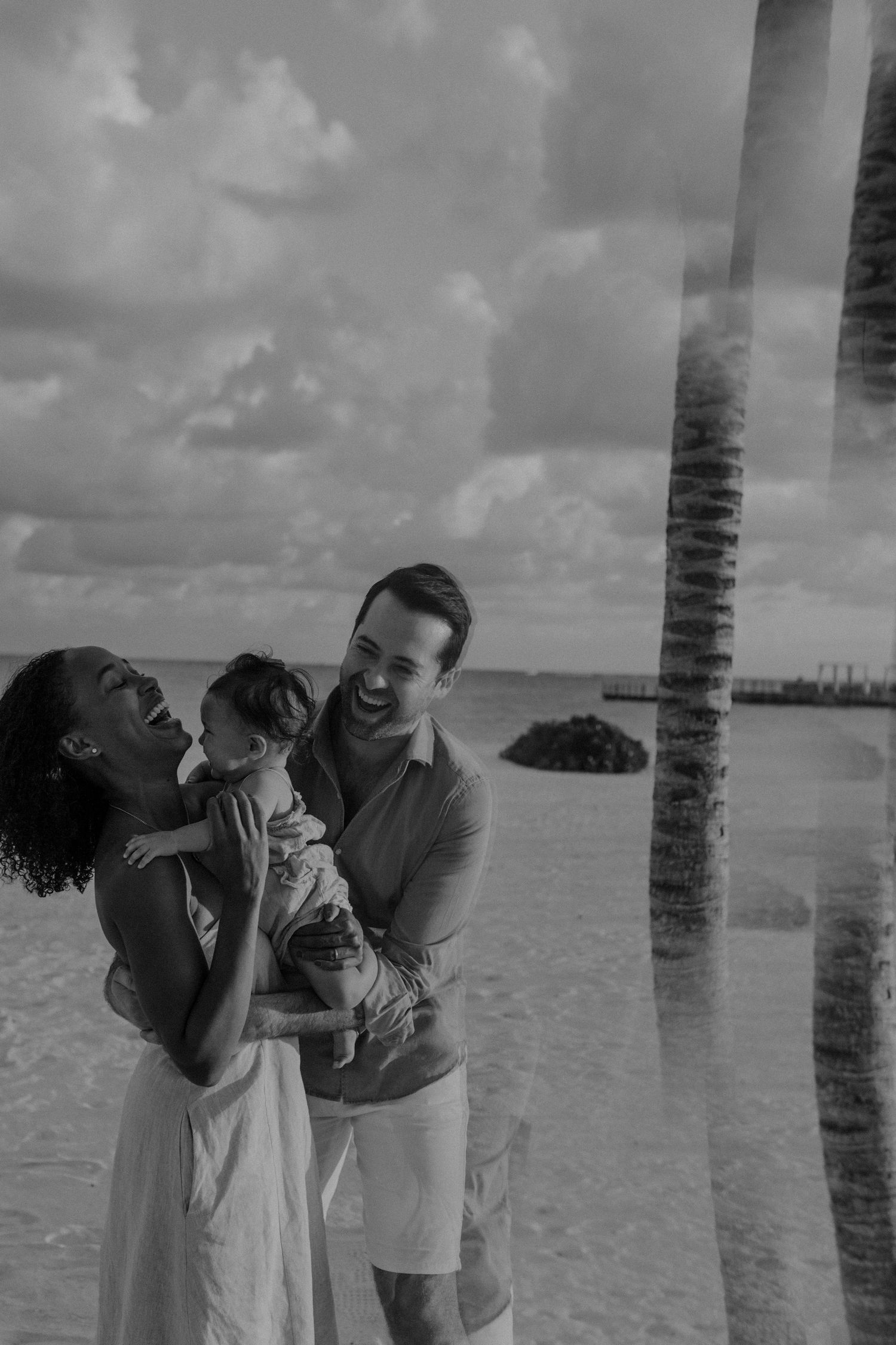 A joyful family moment shared on the beach at The St. Regis Kanai Resort, family photos in Riviera Maya.