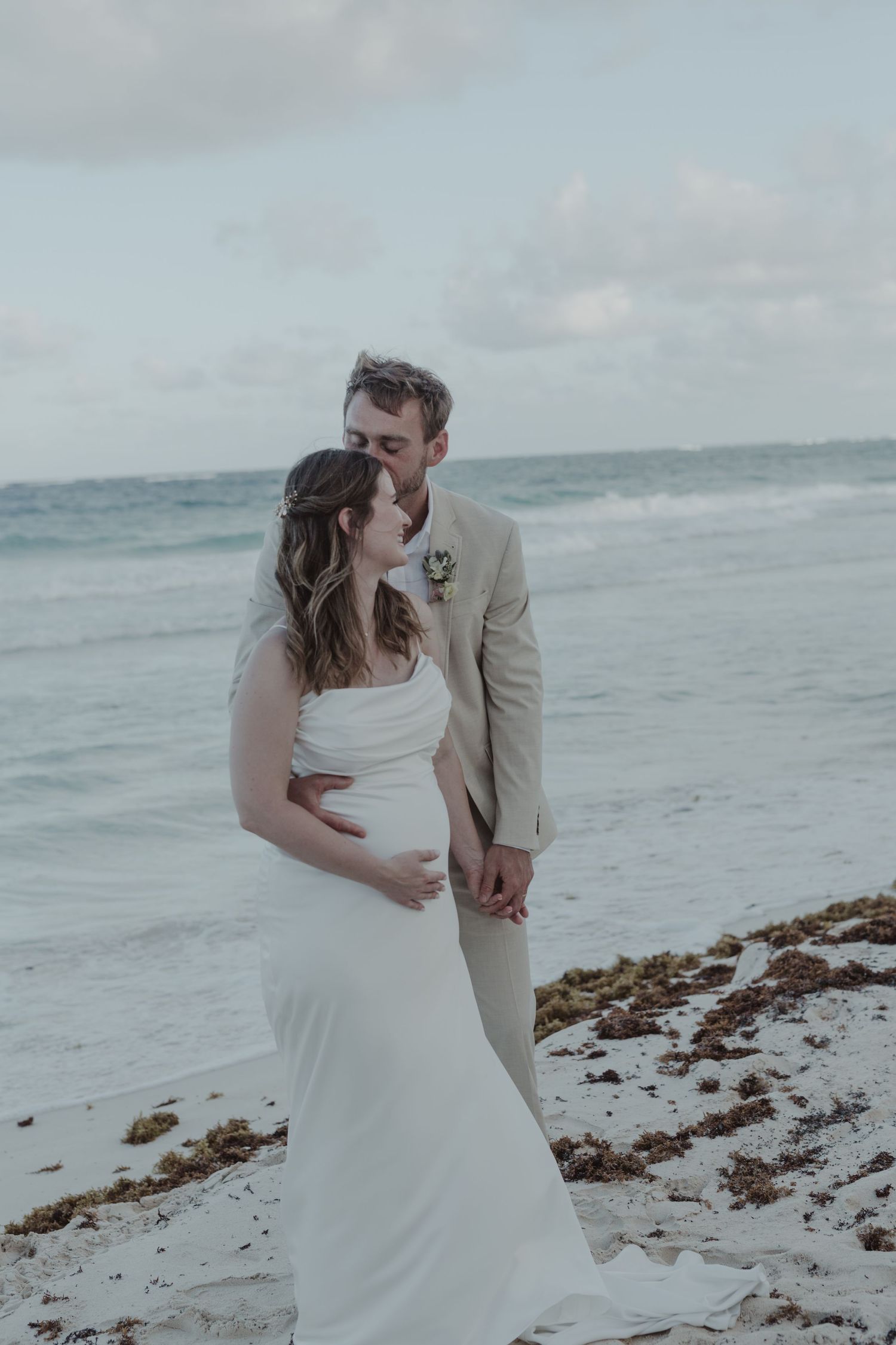 Couple embracing on the beach at La Valise Tulum during intimate elopement Riviera Maya wedding photographer.