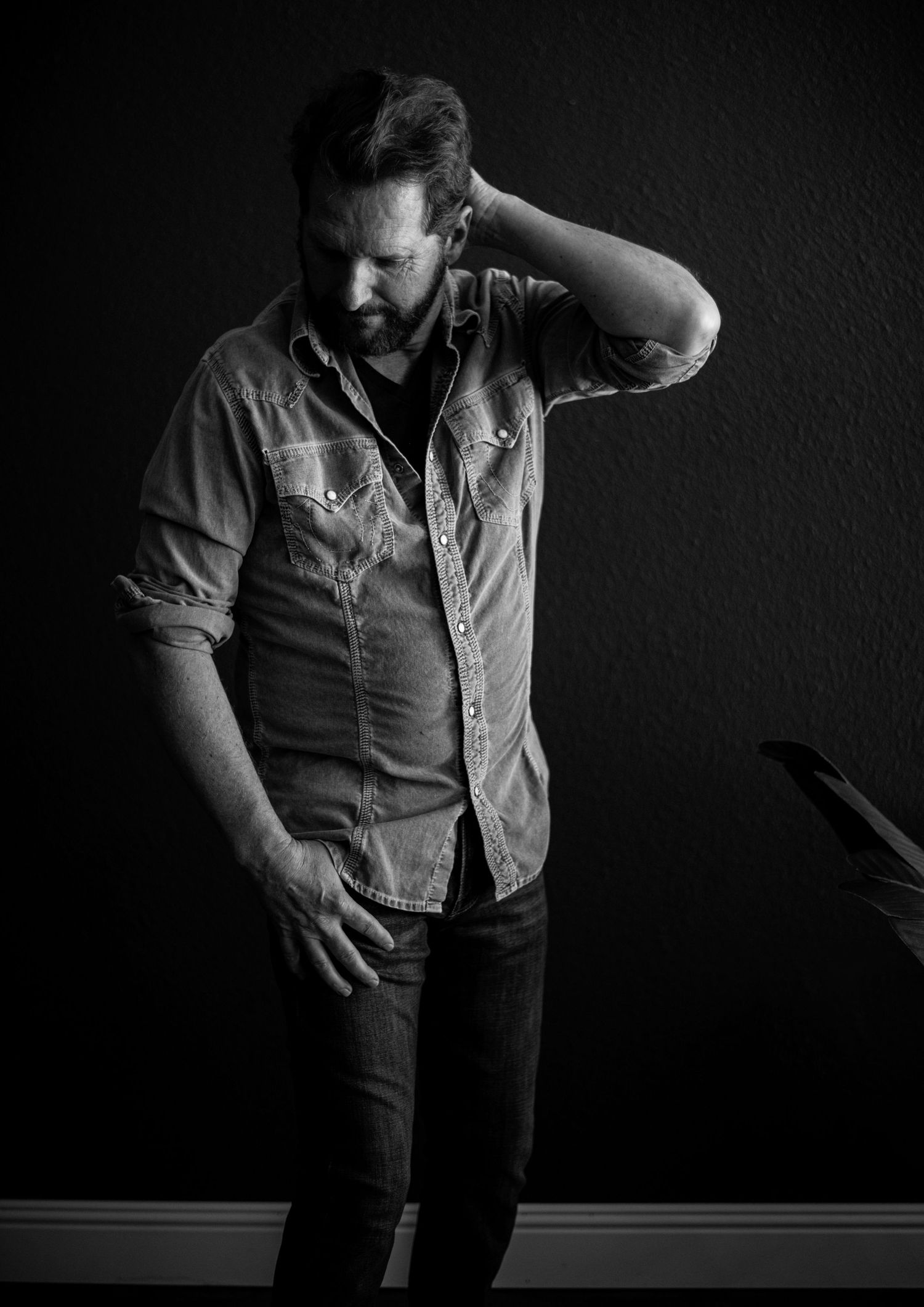 Dark and moody men’s boudoir portrait celebrating strength, confidence, and vulnerability. Luxury men’s boudoir photography highlighting