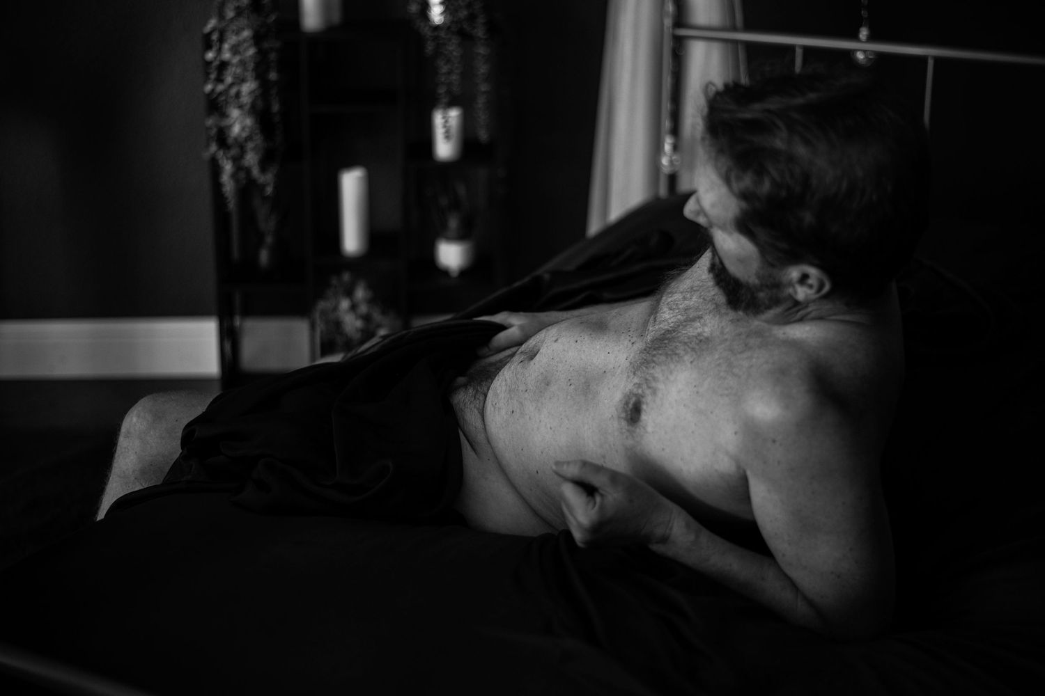 Dark and moody men’s boudoir portrait celebrating strength, confidence, and vulnerability. Luxury dudeoir photo