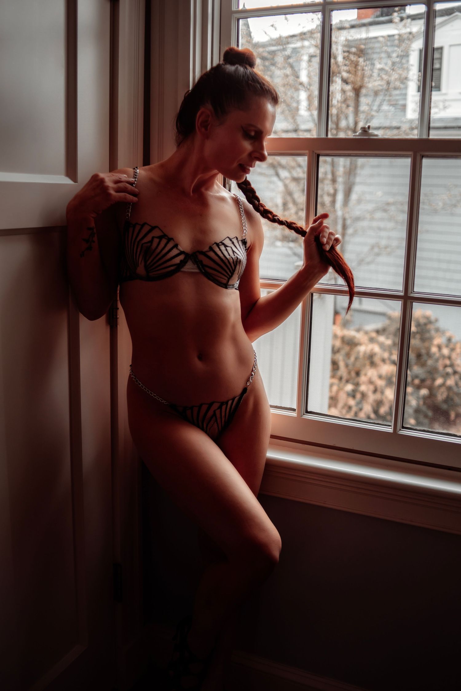 Empowering dark and moody boudoir portrait highlighting natural beauty and confidence. Las Vegas boudoir photographer with private studio.