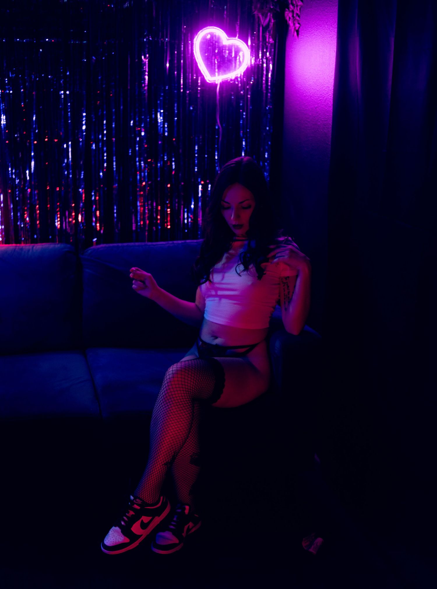 Neon-lit boudoir portrait in Las Vegas — bold colors, dark tones, and pure confidence. Dark and vibrant boudoir detail highlighting color