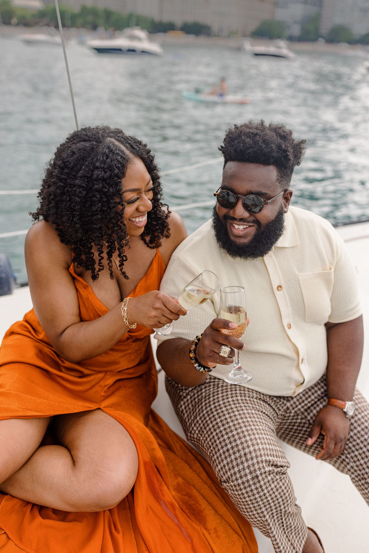 A couple shares drinks and laughs while enjoying a boat ride on Lake Michigan.