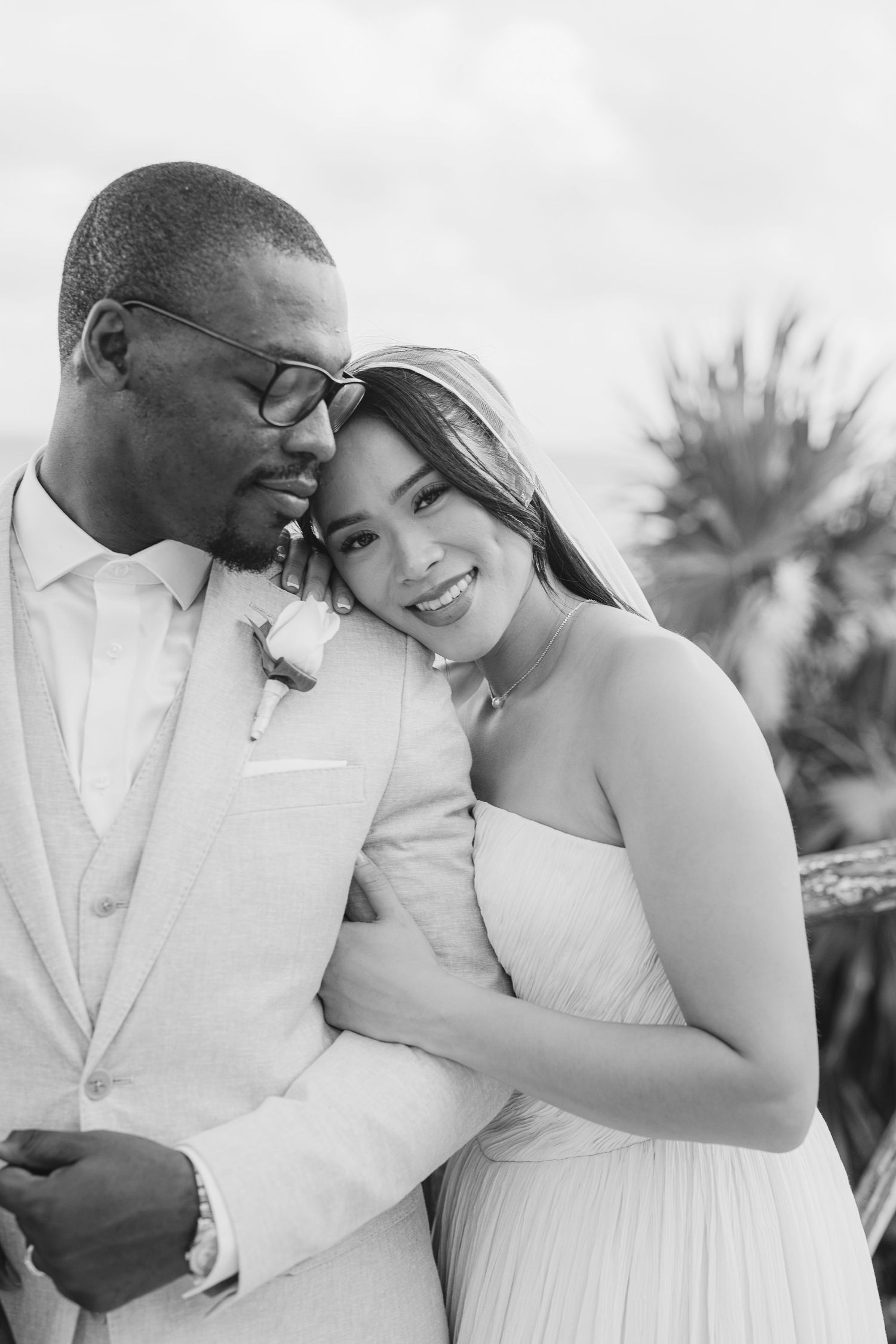 A series of romantic black and white wedding photos showing tender moments between a couple in formal attire.