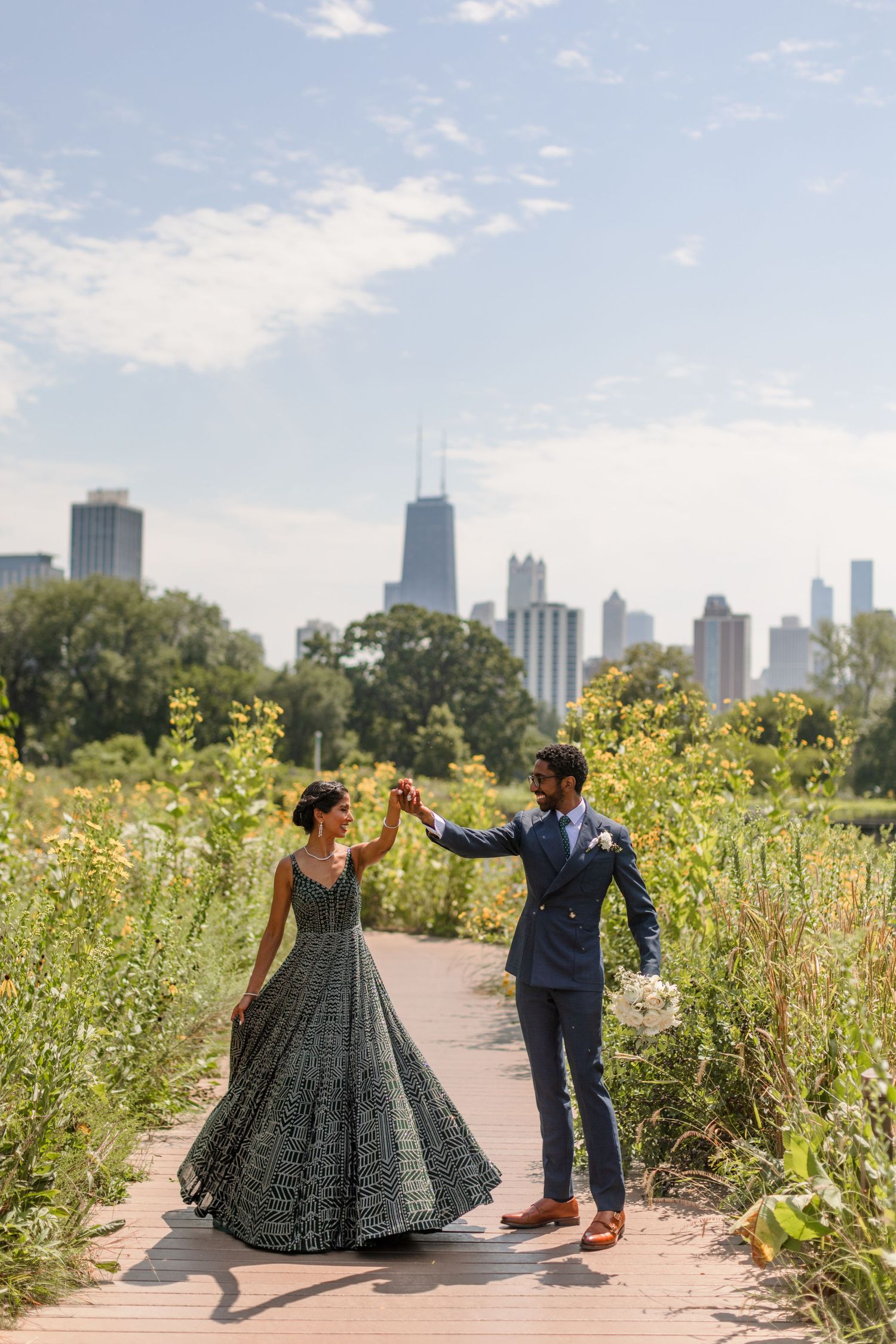 A couple dancing on a path with the Chicago skyline visible in the background.