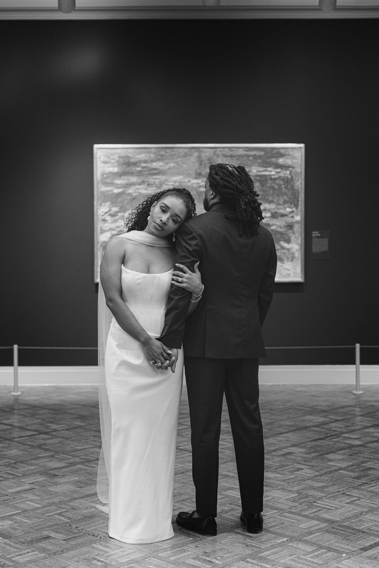 A romantic black and white wedding photo sequence shows a couple embracing while standing on a tiled floor.