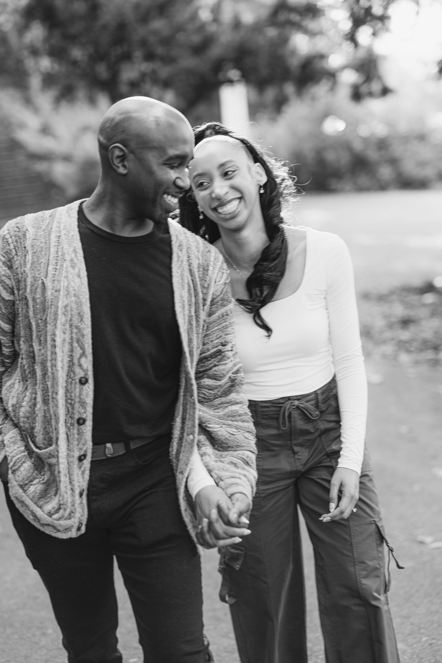 A romantic black and white photo series showing a couple sharing tender moments while walking outdoors.