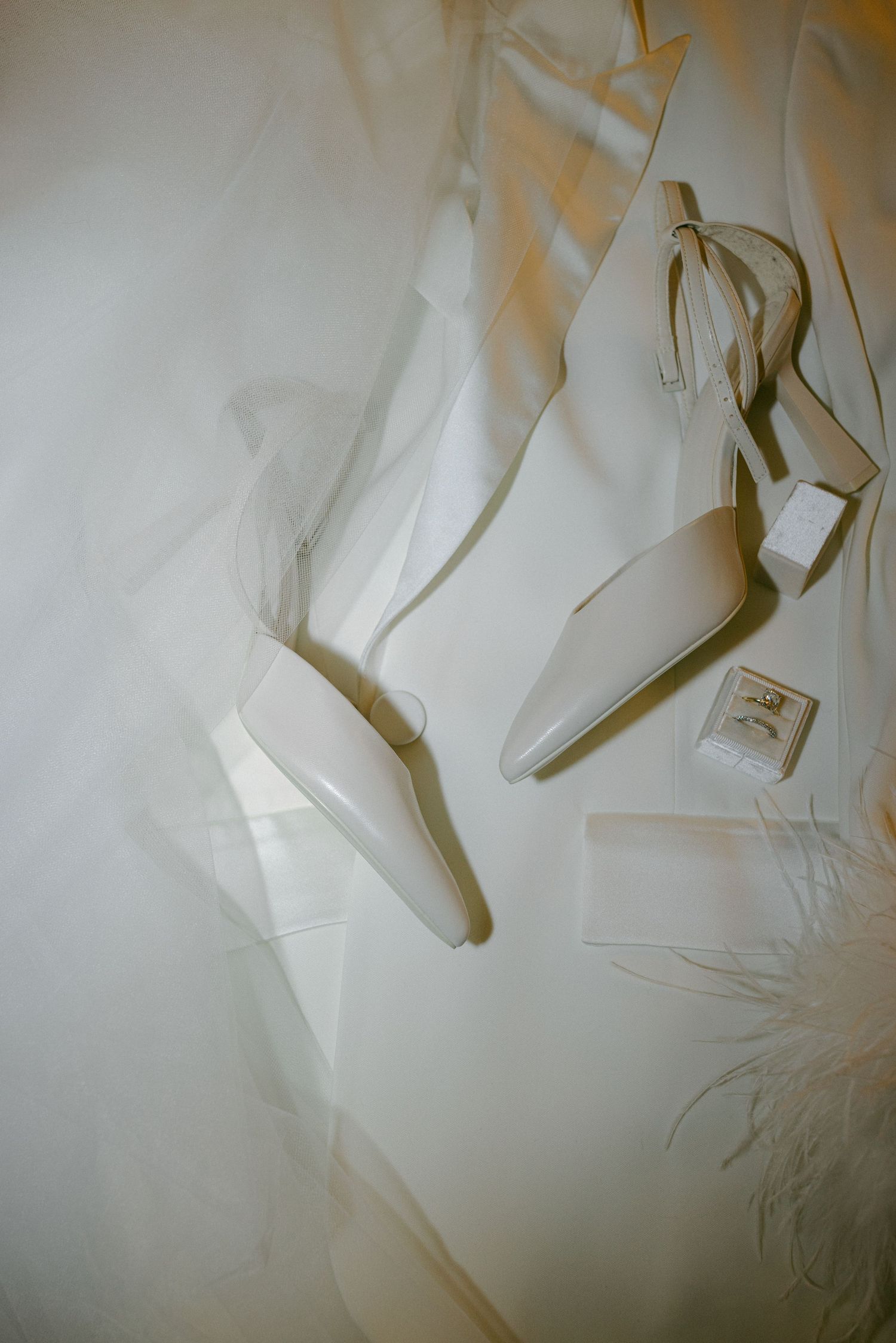 Elegant white bridal shoes displayed against a light background.