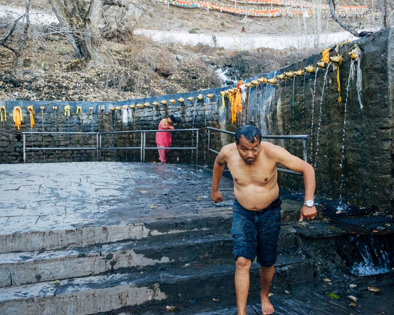 A sequence of photos showing someone diving into a natural swimming pool with stone walls in a wooded setting.
